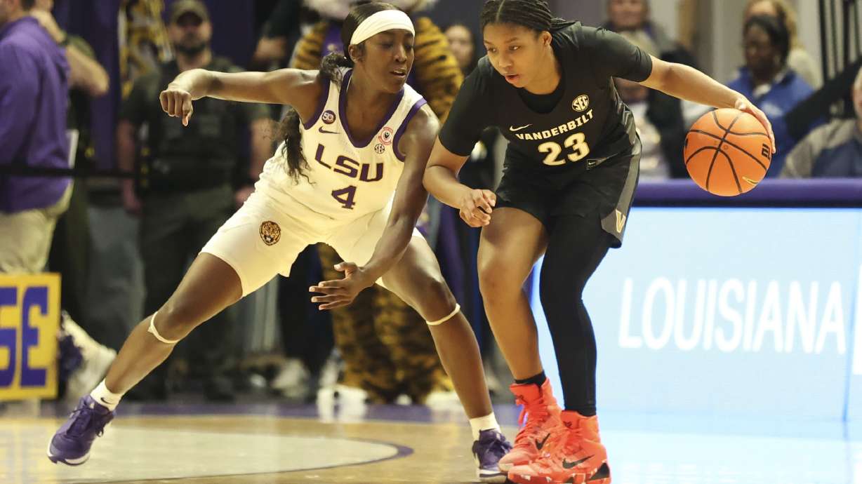 LSU guard Flau'Jae Johnson (4) defends against Vanderbilt guard Iyana Moore (23) during the second half of an NCAA college basketball game in Baton Rouge, La., Monday, Jan. 13, 2025.