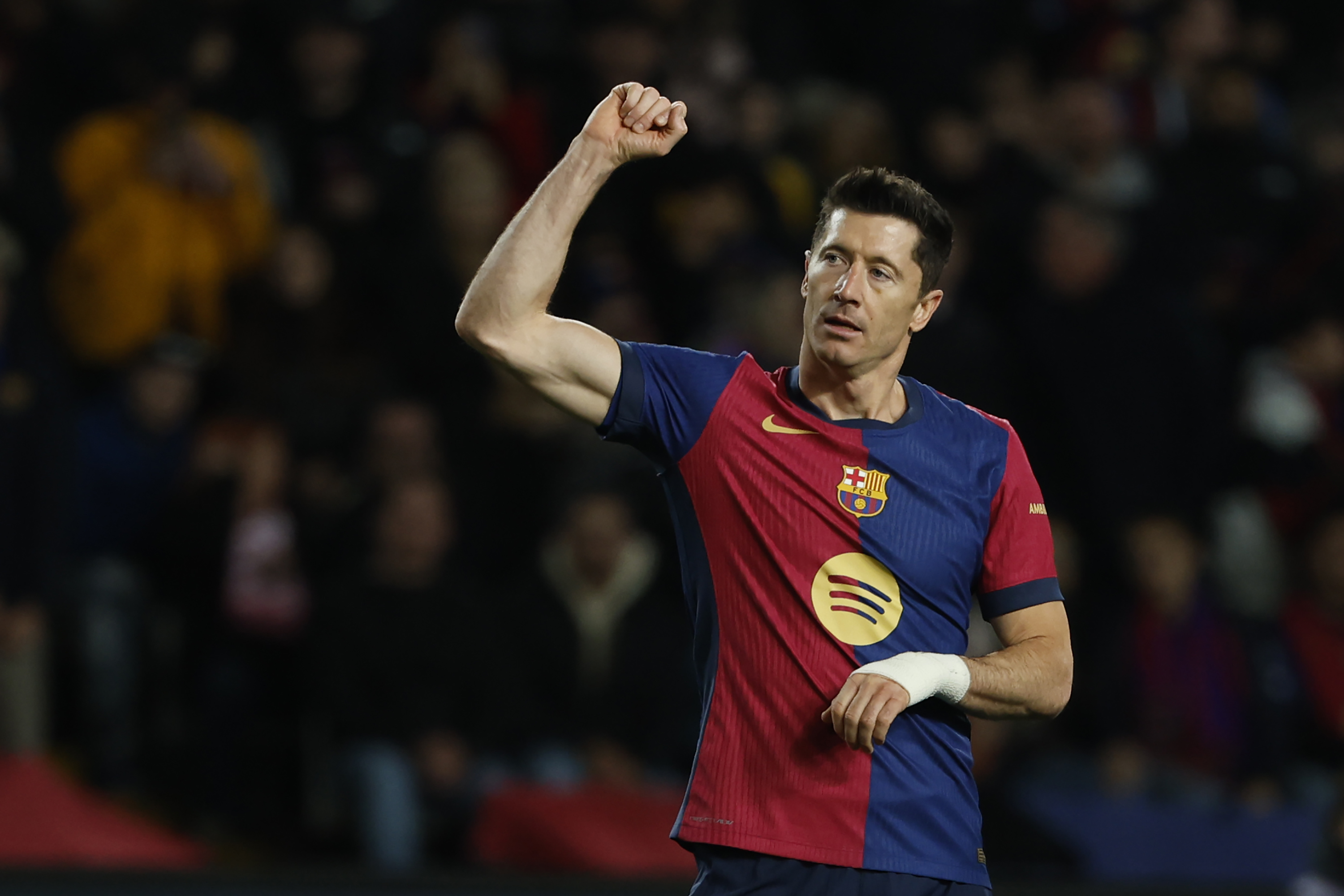 Barcelona's Robert Lewandowski celebrates after scoring his side's sixth goal during the Spanish La Liga soccer match between Barcelona and Valencia at the Lluis Companys Olympic Stadium in Barcelona, Spain, Sunday, Jan. 26, 2025. 