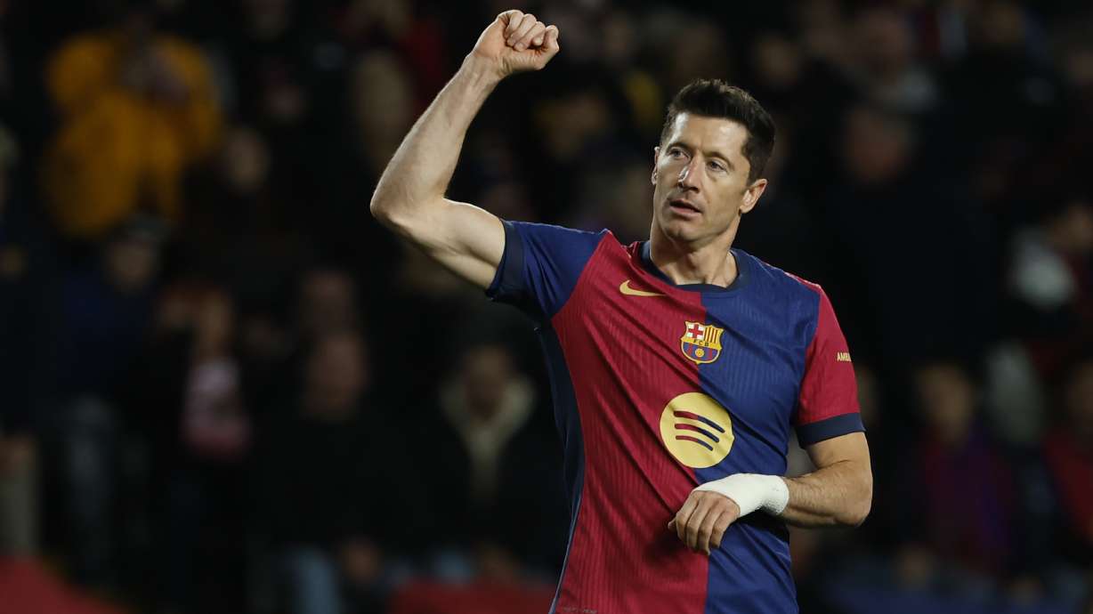 Barcelona's Robert Lewandowski celebrates after scoring his side's sixth goal during the Spanish La Liga soccer match between Barcelona and Valencia at the Lluis Companys Olympic Stadium in Barcelona, Spain, Sunday, Jan. 26, 2025.
