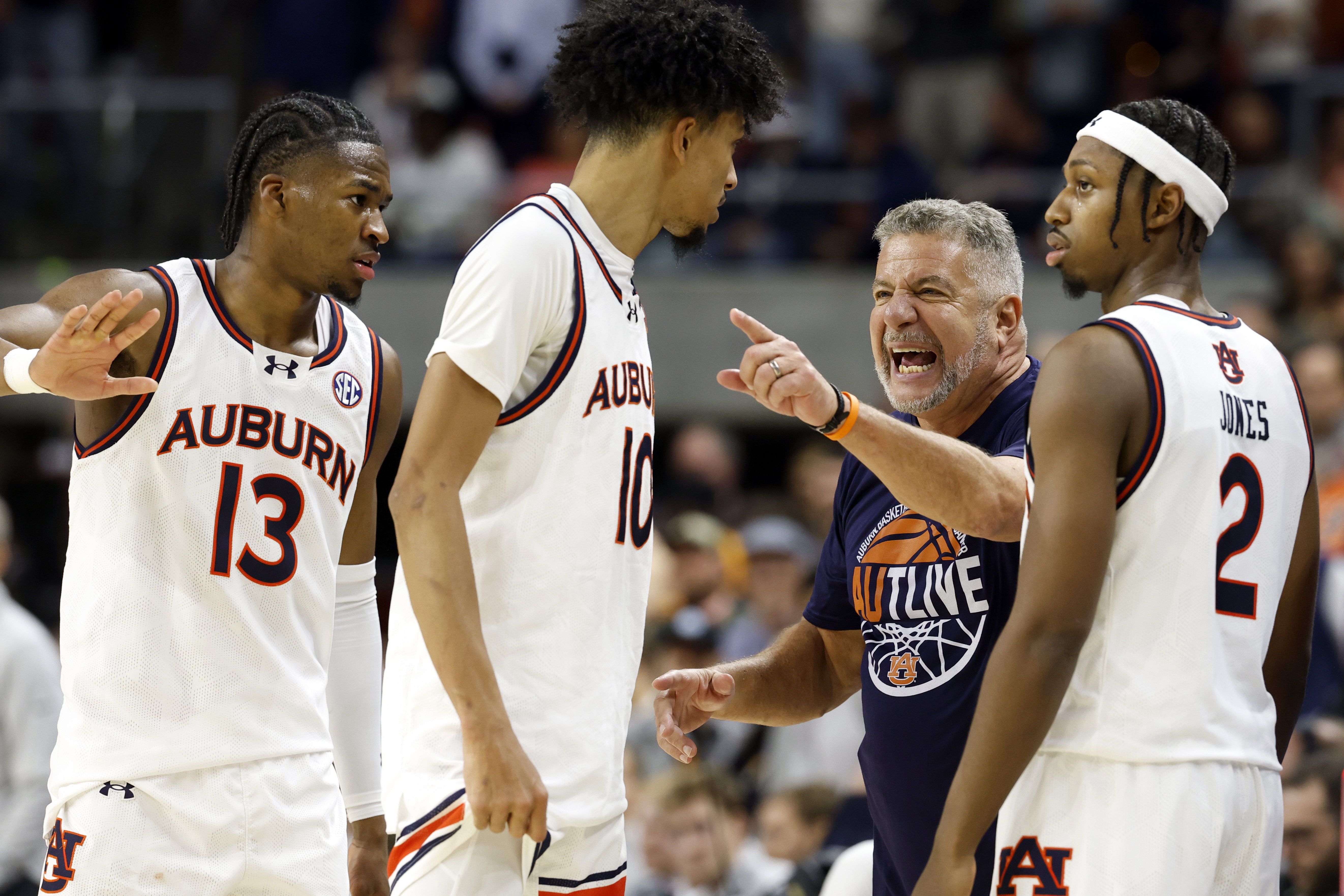 Auburn head coach Bruce Pearl, second from right, talks with players during a timeout in the second half of an NCAA college basketball game against Tennessee, Saturday, Jan. 25, 2025, in Auburn, Ala. 