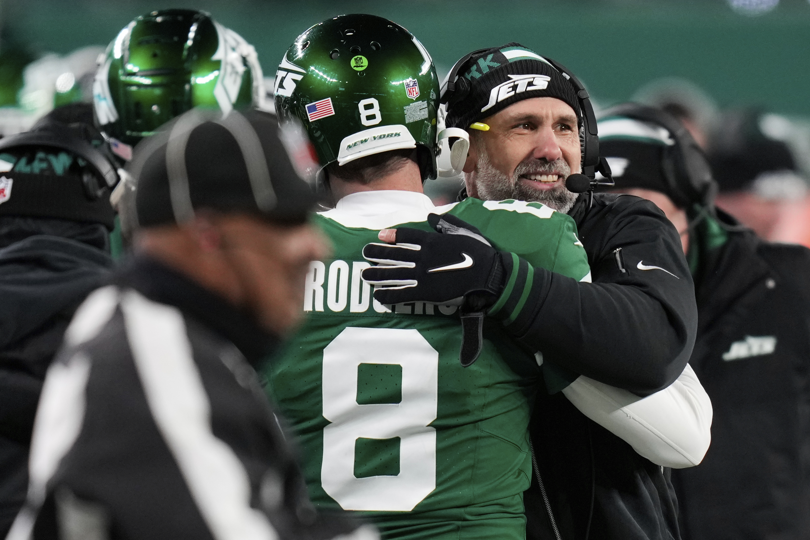 New York Jets quarterback Aaron Rodgers (8) and head coach Jeff Ulbrich, right, hug during the second half of an NFL football game against the Miami Dolphins, Sunday, Jan. 5, 2025, in East Rutherford, N.J. 