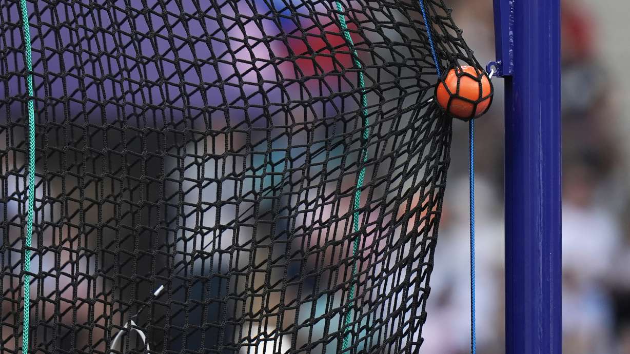 FILE - A hammer is caught by the safety net during the men's hammer throw qualification at the 2024 Summer Olympics, Aug. 2, 2024, in Saint-Denis, France.