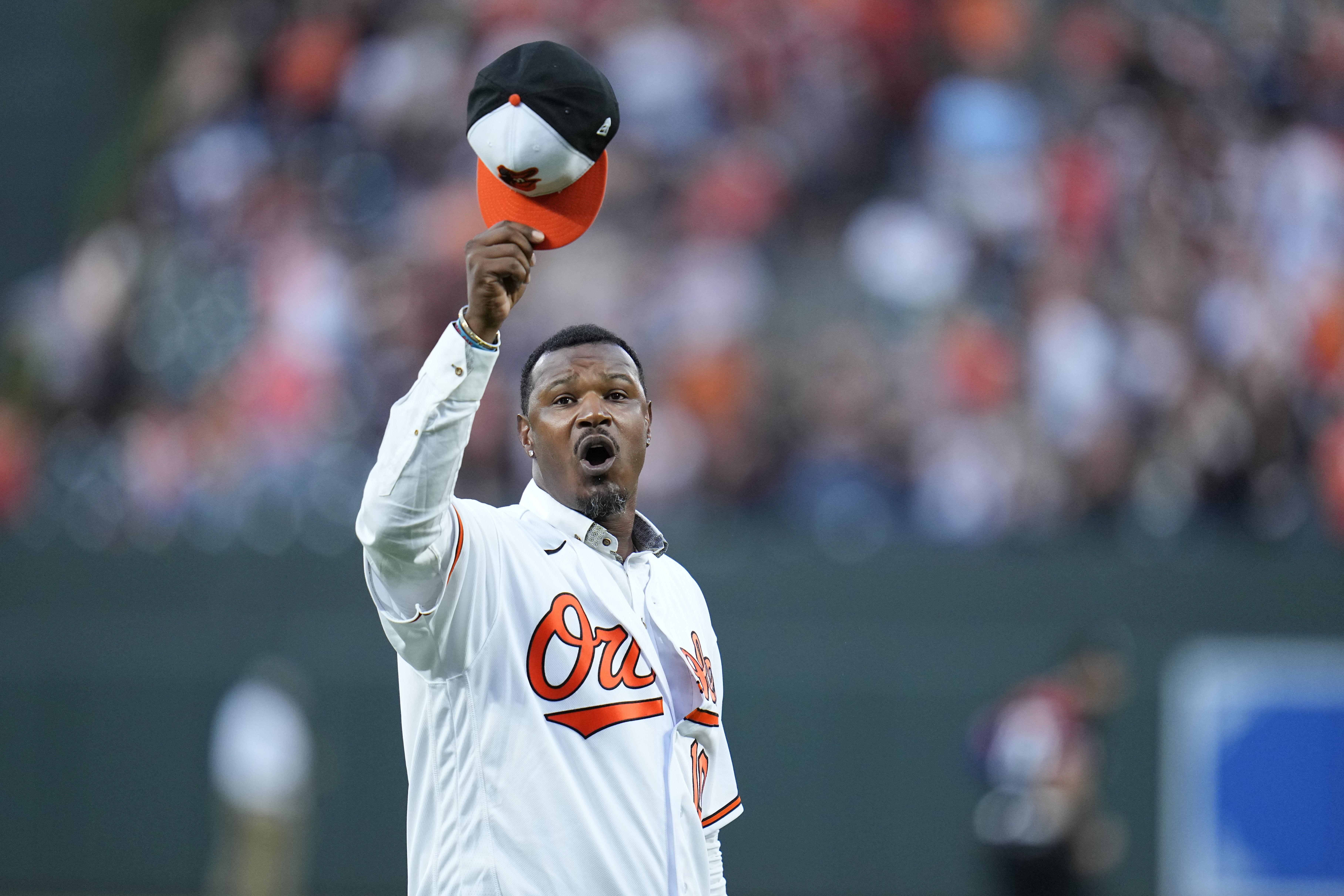 FILE - Former Baltimore Orioles player Adam Jones raises his cap on the field during a pregame ceremony, Sept. 15, 2023, in Baltimore.