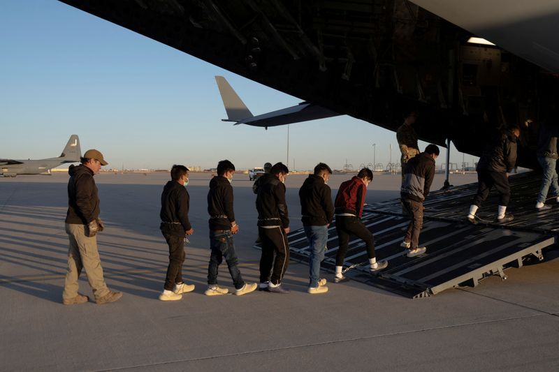 Migrants board a C-17 Globemaster III aircraft for a removal flight at Fort Bliss, Texas, Jan. 23.