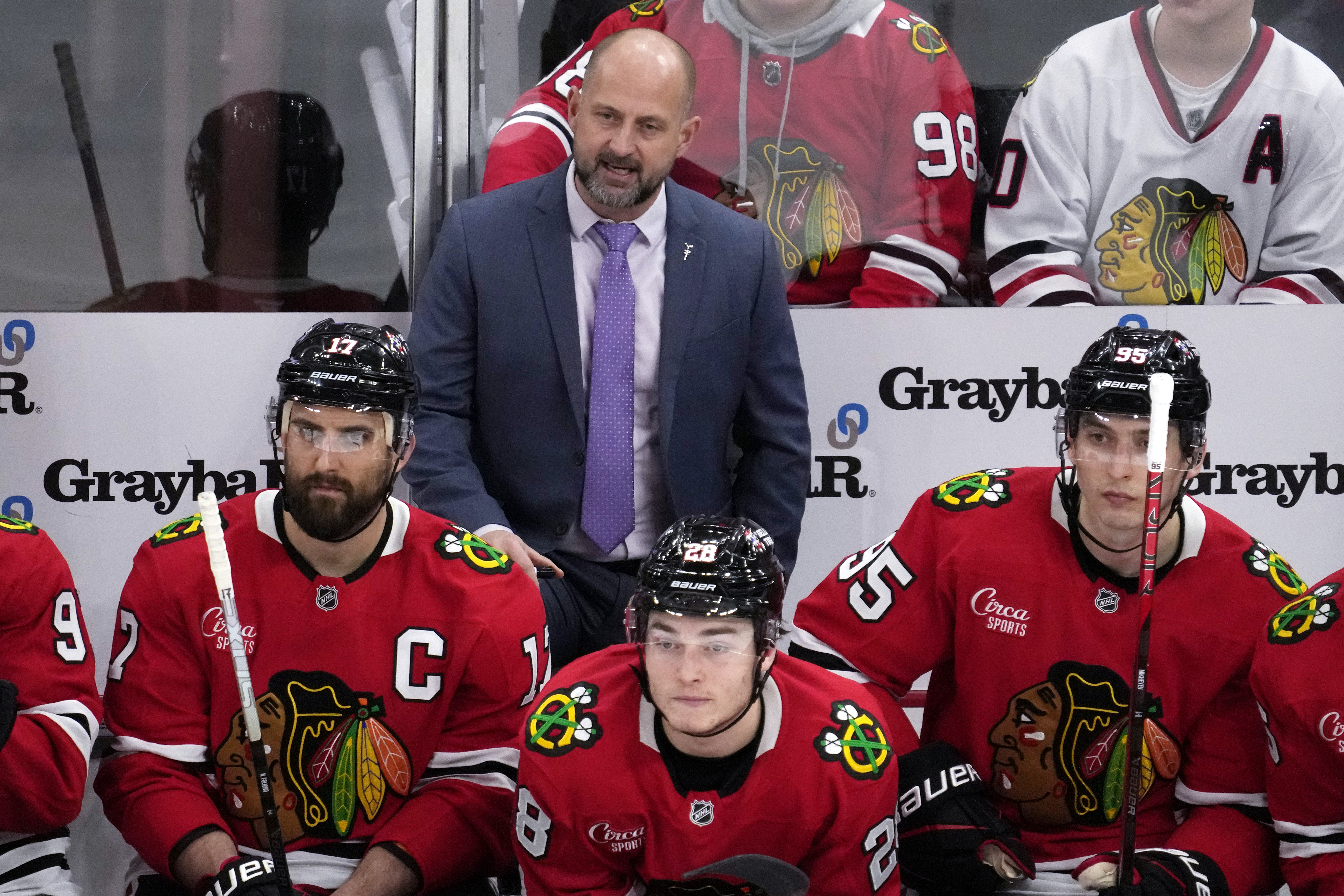 Chicago Blackhawks head coach Anders Sorensen, center top, watches his team during the third period of an NHL hockey game against the Minnesota Wild in Chicago, Sunday, Jan. 26, 2025. 