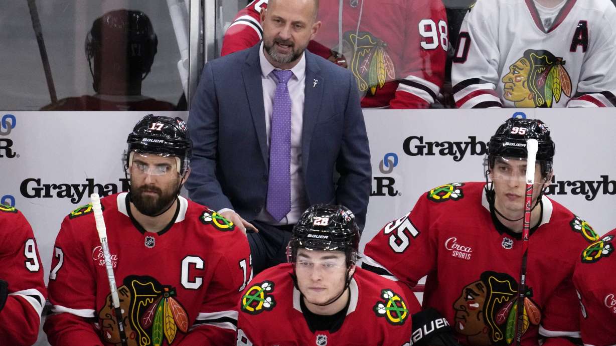 Chicago Blackhawks head coach Anders Sorensen, center top, watches his team during the third period of an NHL hockey game against the Minnesota Wild in Chicago, Sunday, Jan. 26, 2025.