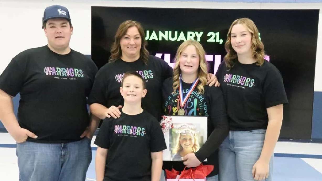 Enterprise Elementary sixth grader Whitlee Holt poses with her three siblings, from left to right, Braiden, Heston and Hadlee Holt, and their mother Randi Holt shortly after Whitlee was named the "Kindest Kid in America," in Enterprise, Jan. 21.