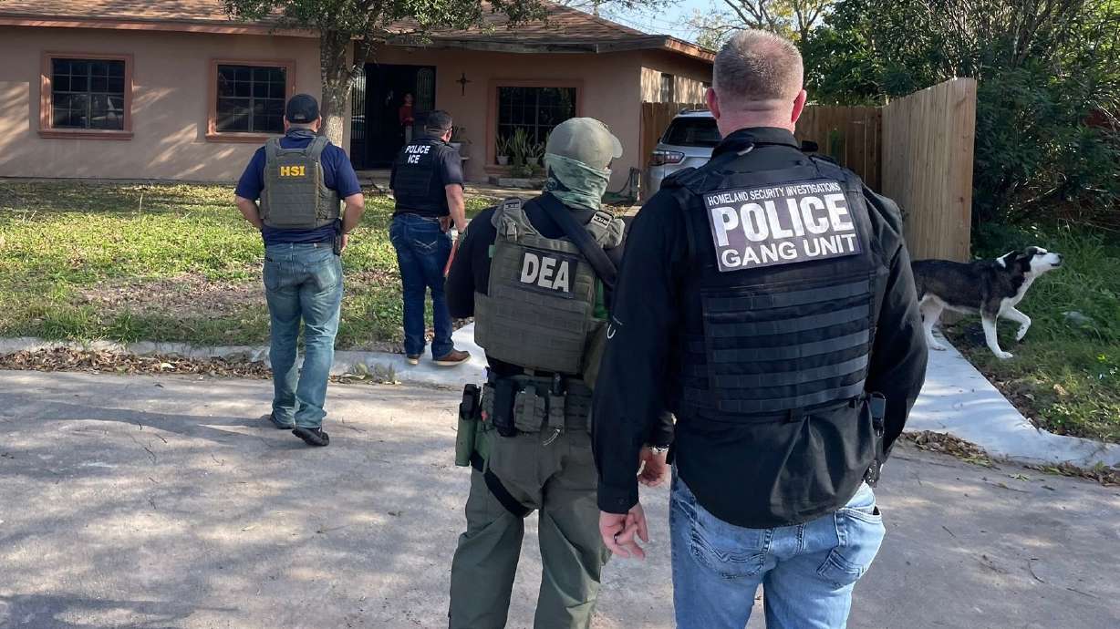 The photo from Sunday shows an immigration enforcement action involving Immigration and Customs Enforcement officials and other federal agents in the Houston, Texas, area. Utah officials say their immigration enforcement efforts will be focused on "anybody with criminal activity."
