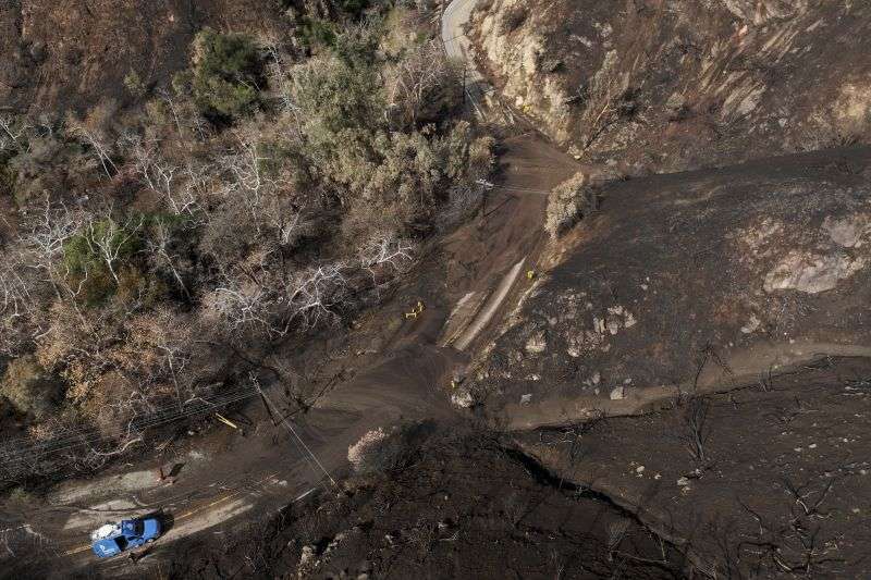Mud covers Topanga Canyon Rd. on the Palisades Fire burn area after a series of weekend storms Monday, near Malibu, Calif.