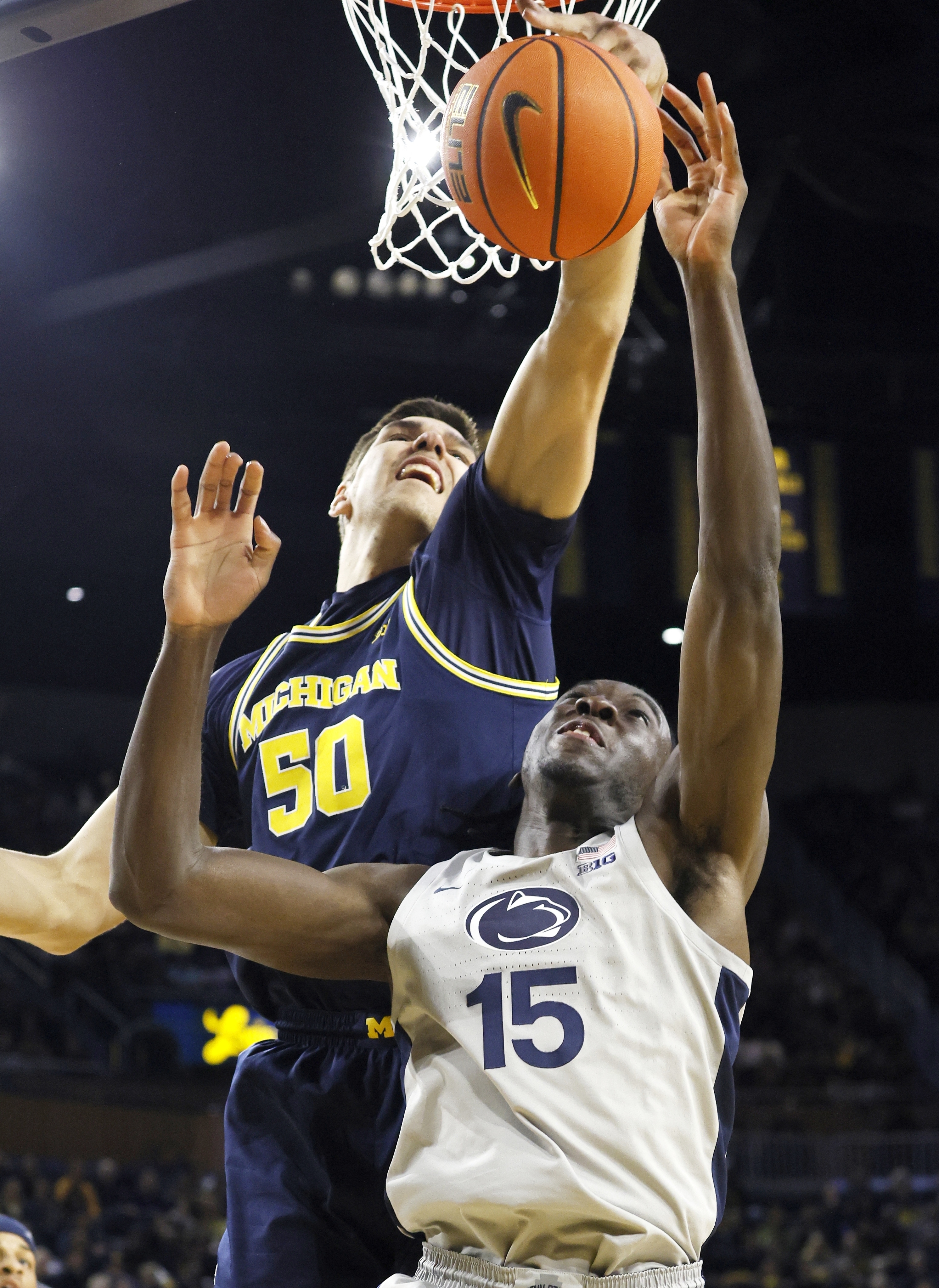 Michigan center Vladislav Goldin (50) blocks a shot-attempt by Penn State forward Kachi Nzeh (15) during the first half of an NCAA college basketball game Monday, Jan. 27, 2025, in Ann Arbor, Mich. 