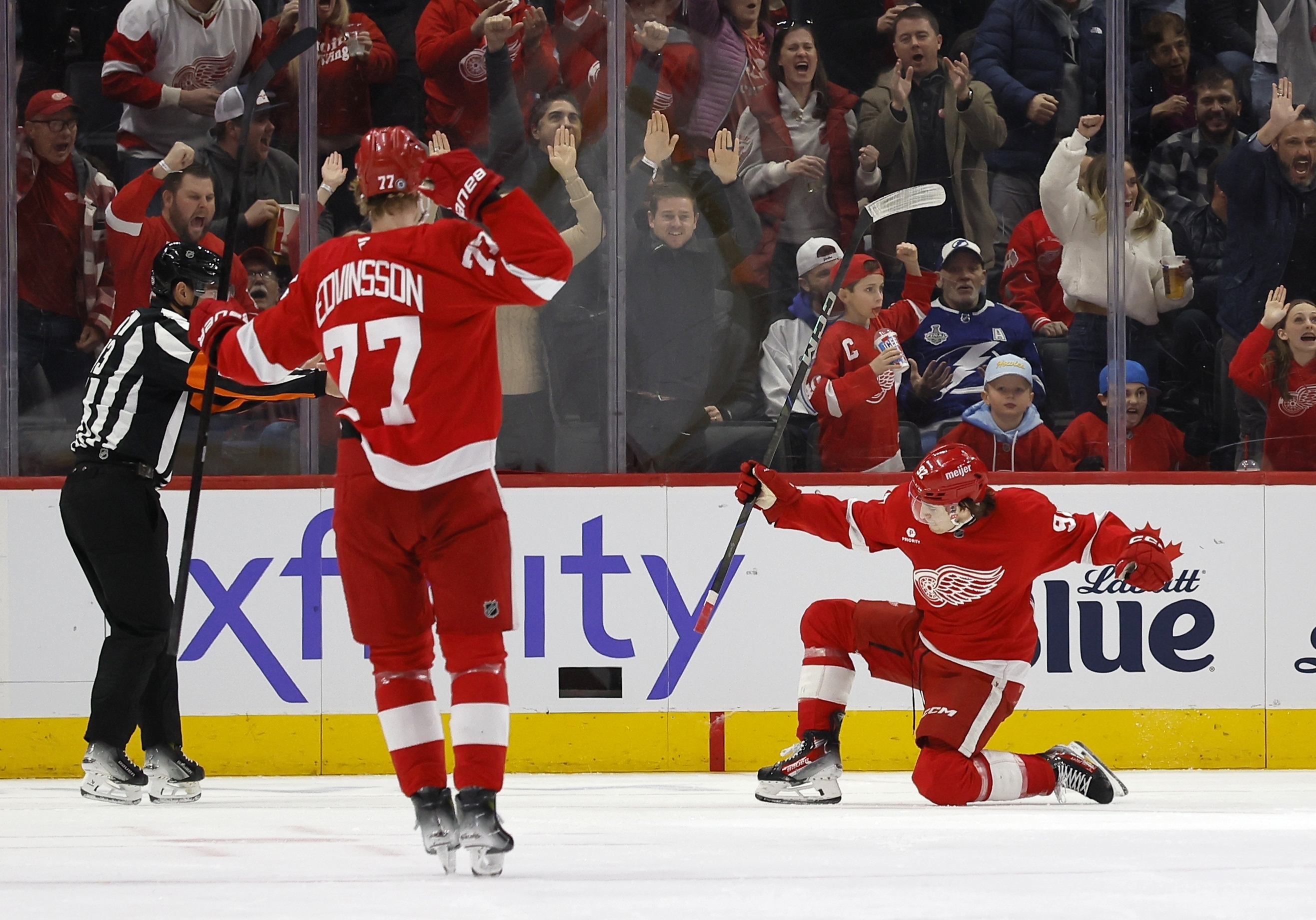 Detroit Red Wings center Marco Kasper (92) celebrates his goal against the Tampa Bay Lightning with defenseman Simon Edvinsson (77) during the second period of an NHL hockey game Saturday, Jan. 25, 2025, in Detroit. 