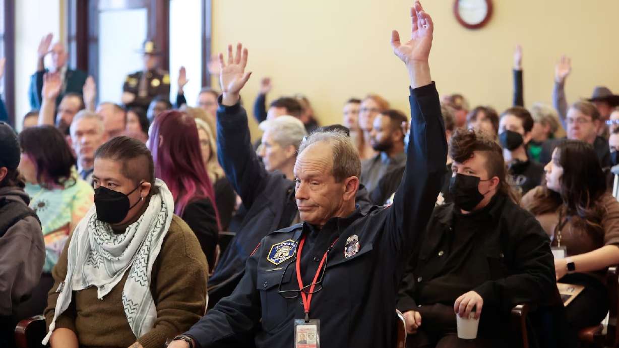Firefighters and others raise heir hands to show they oppose HB 267 Public Sector Labor Union Amendments during a House Business, Labor, and Commerce Committee meeting at the Capitol in Salt Lake City on Jan. 23. The committee voted to pass the bill.