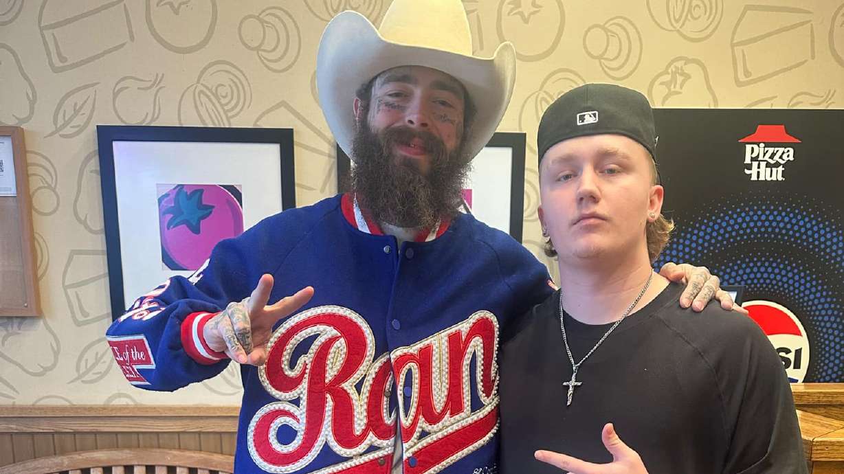 Pizza Hut manager Kolby Aguila poses with Post Malone in Cottonwood Heights on Saturday. The musician left the manager a huge tip.