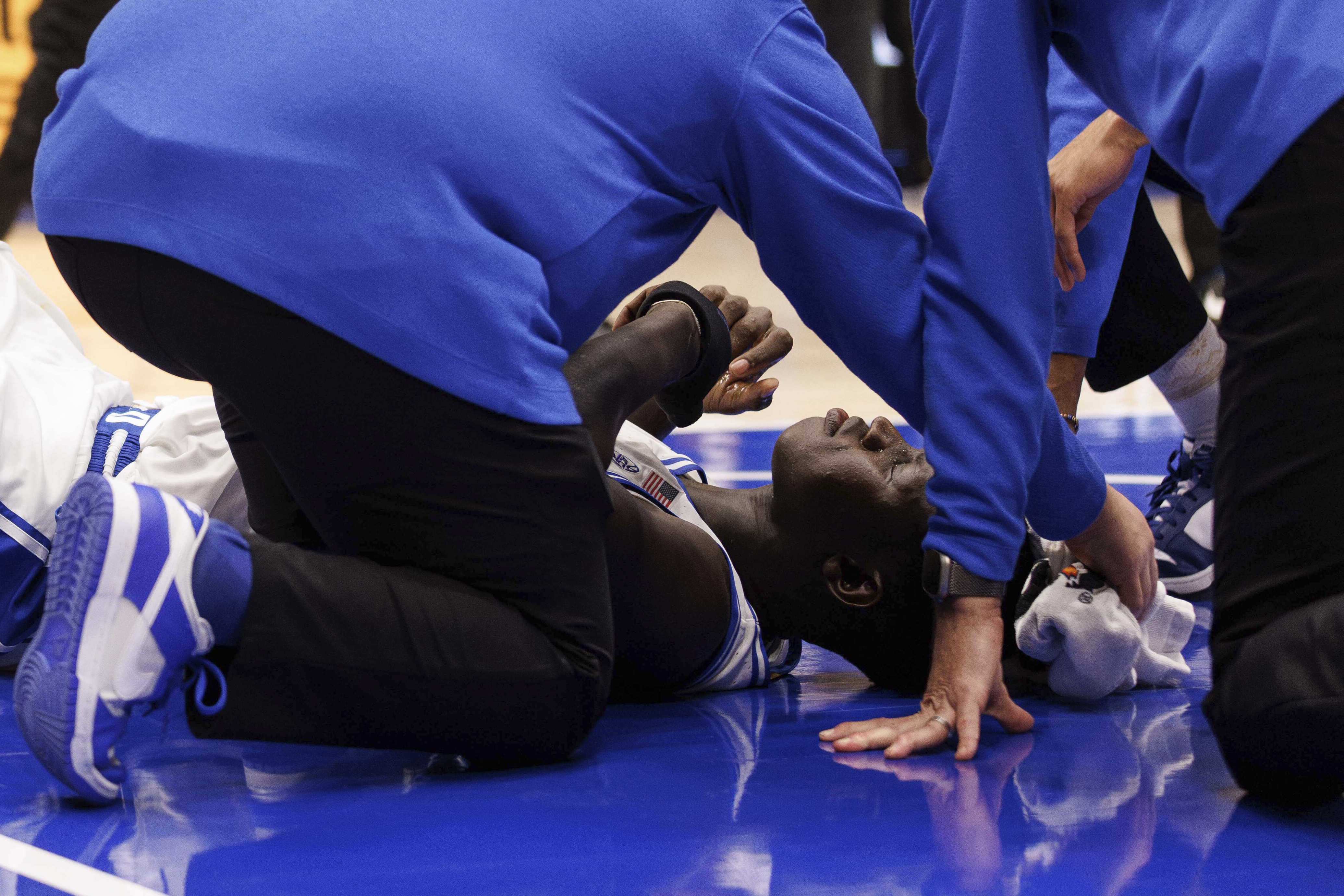 Duke's Khaman Maluach (9) is helped by staff after falling ill during the second half of an NCAA college basketball game against North Carolina State in Durham, N.C., Monday, Jan. 27, 2025. 