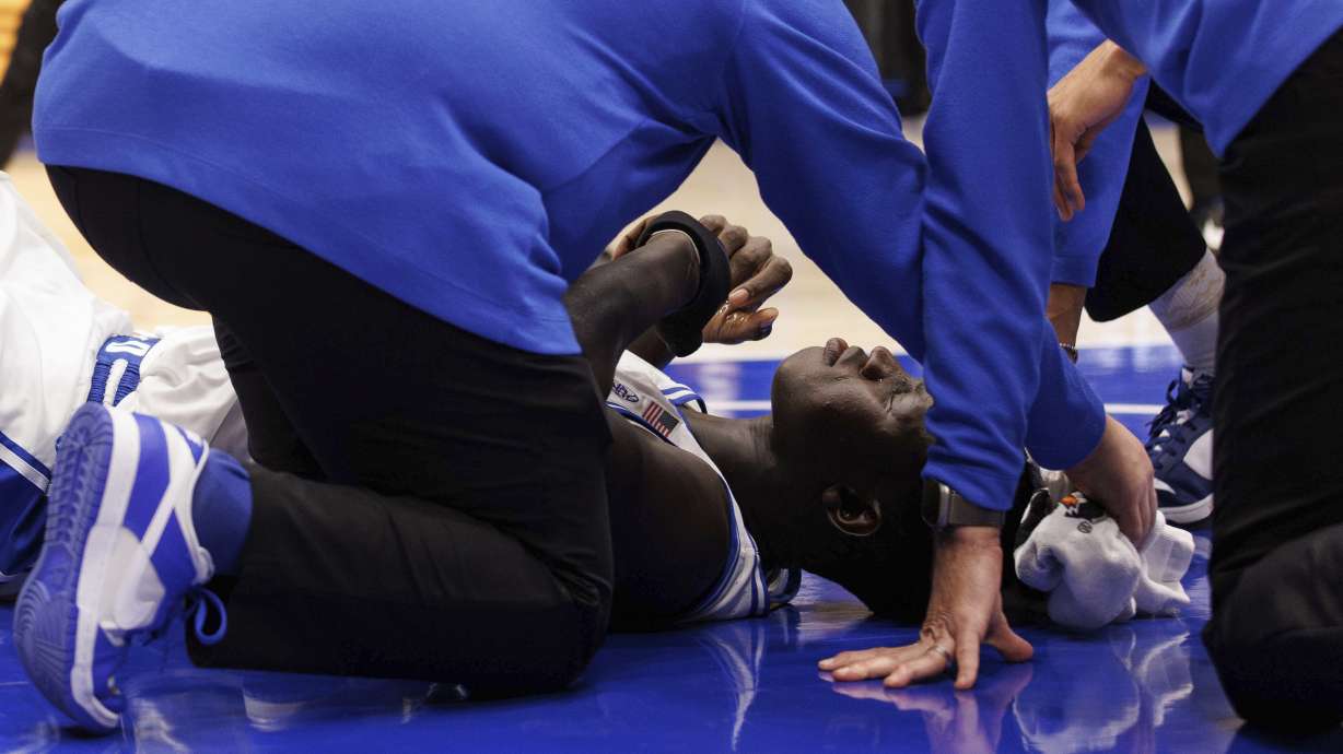 Duke's Khaman Maluach (9) is helped by staff after falling ill during the second half of an NCAA college basketball game against North Carolina State in Durham, N.C., Monday, Jan. 27, 2025.