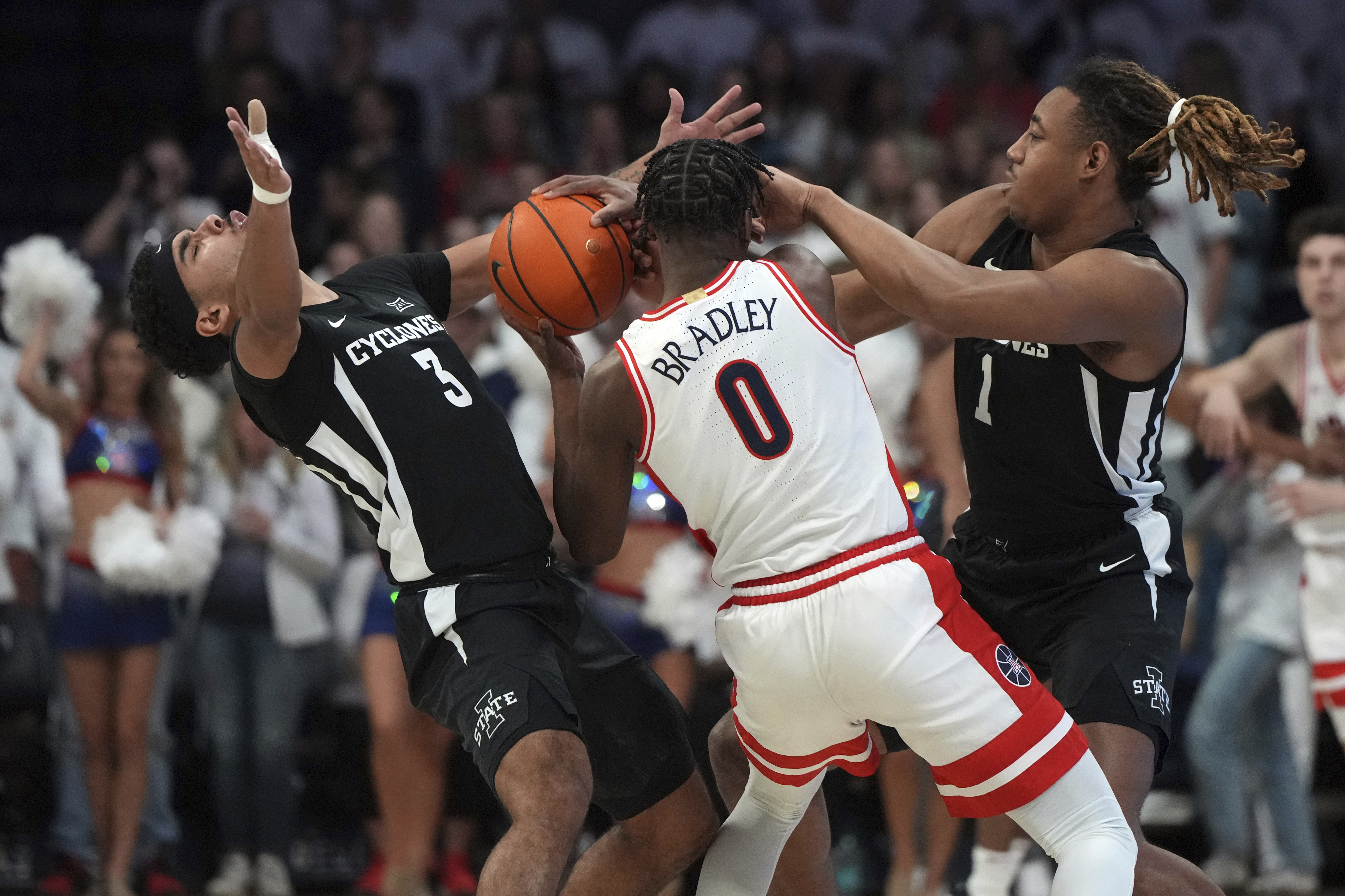 Iowa State guard Tamin Lipsey (3) and center Dishon Jackson (1) pressure Arizona guard Jaden Bradley (0) during the first half of an NCAA college basketball game, Monday, Jan. 27, 2025, in Tucson, Ariz. 