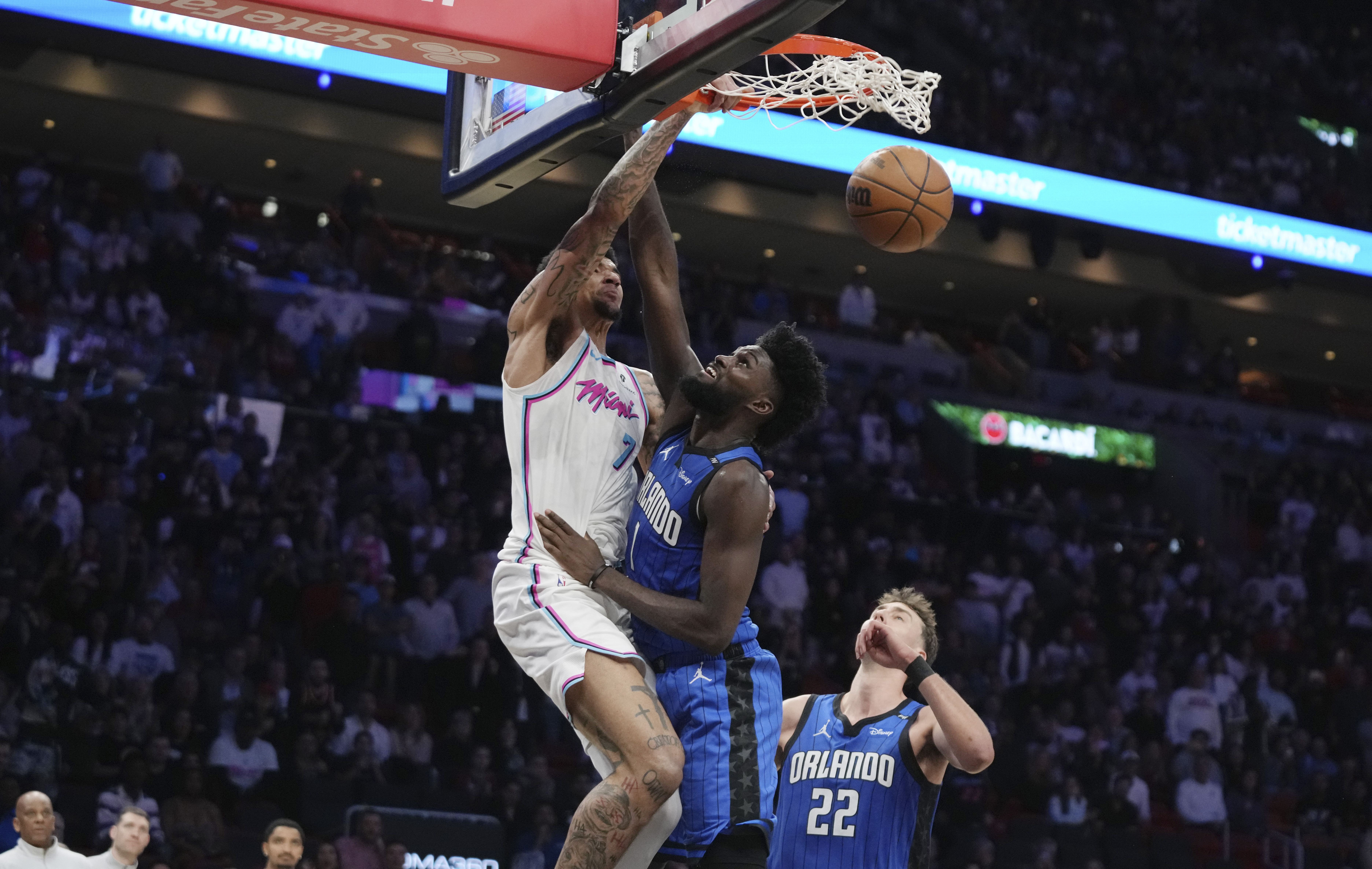 Miami Heat center Kel'el Ware, left, dunks over Orlando Magic forward Jonathan Isaac, center, during the second half of an NBA basketball game, Monday, Jan. 27, 2025, in Miami. 