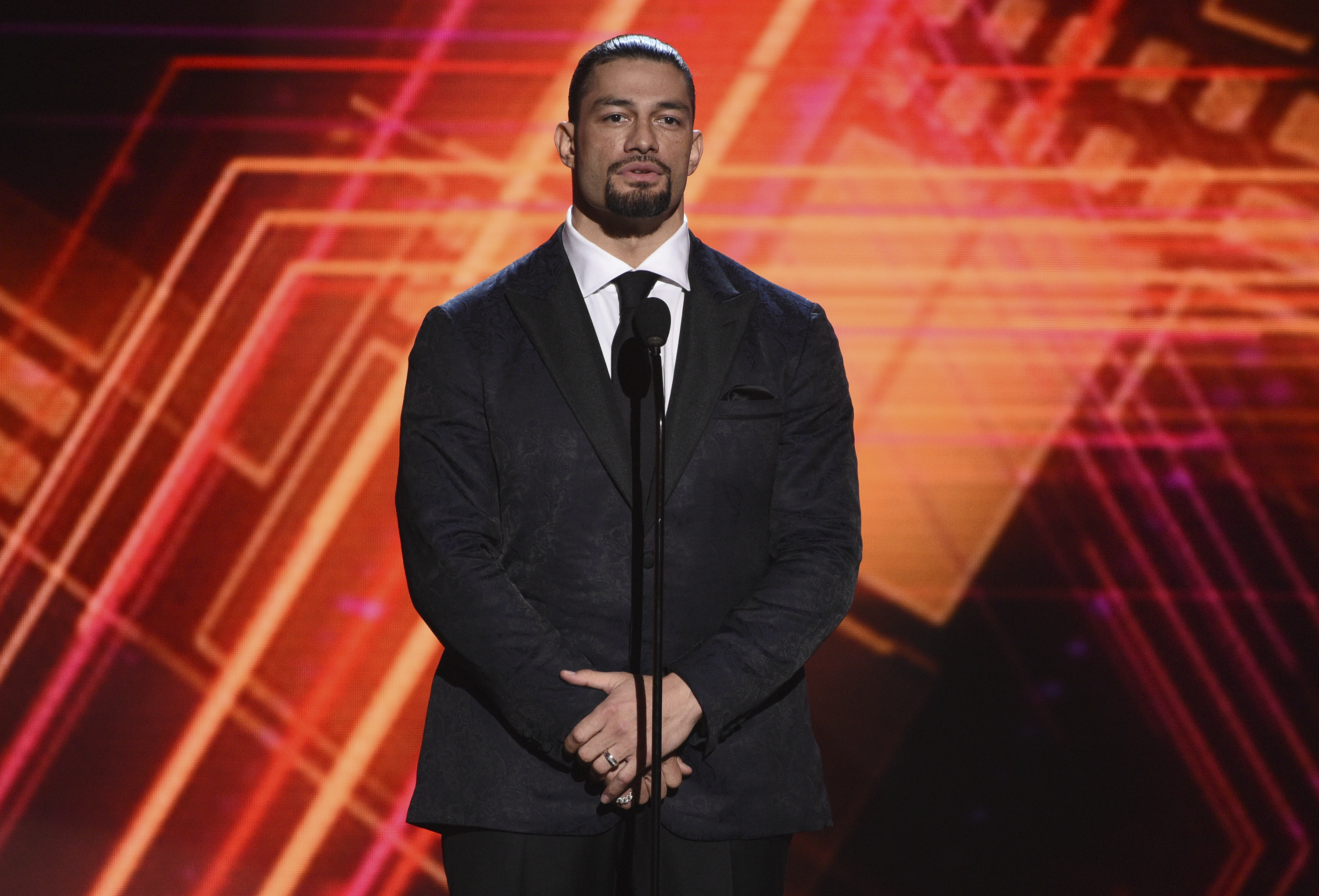 FILE - Roman Reigns presents the best coach award at the ESPY Awards on Wednesday, July 10, 2019, at the Microsoft Theater in Los Angeles. 