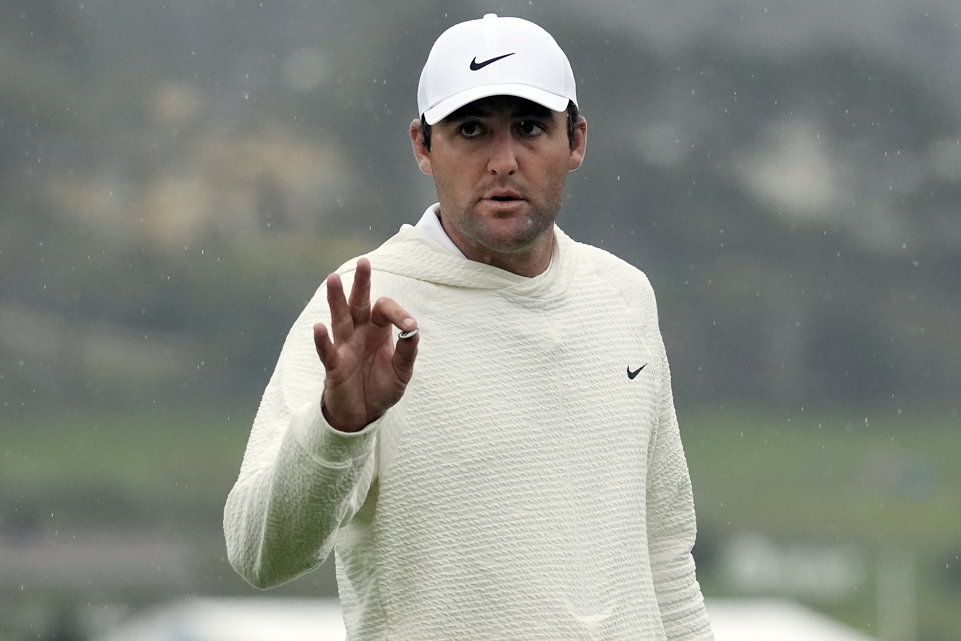 FILE - Scottie Scheffler gestures on the 18th green at Pebble Beach Golf Links during the third round of the AT&T Pebble Beach National Pro-Am golf tournament in Pebble Beach, Calif., Saturday, Feb. 3, 2024. 