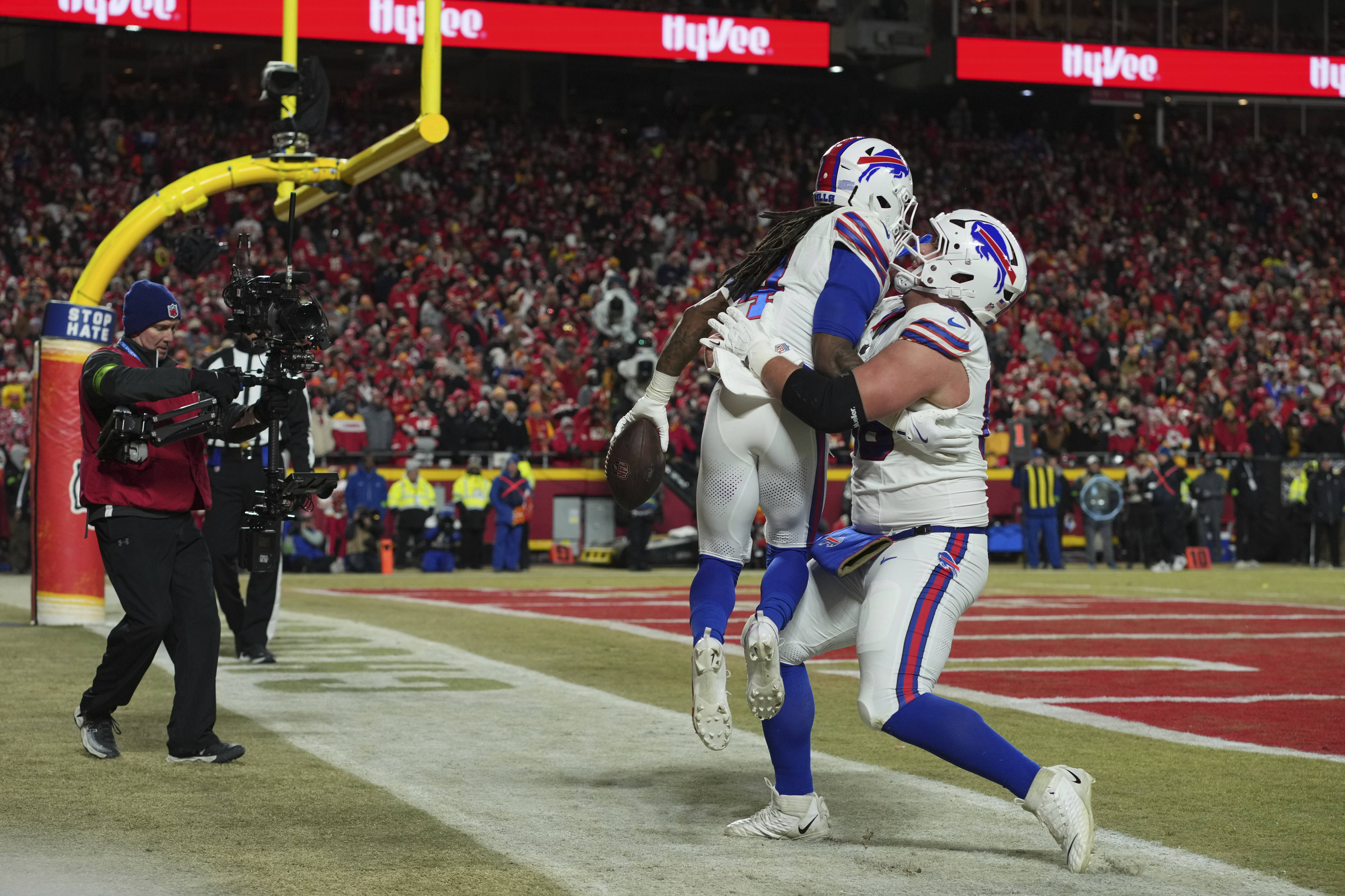 Buffalo Bills running back James Cook (4) is congratulated by teammate guard Connor McGovern, right, after scoring during the first half of the AFC Championship NFL football game against the Kansas City Chiefs, Sunday, Jan. 26, 2025, in Kansas City, Mo. 