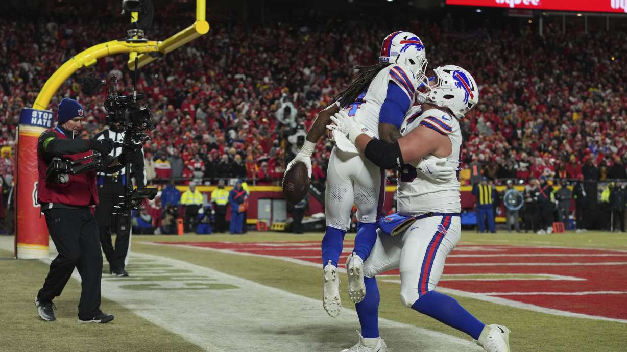 Buffalo Bills running back James Cook (4) is congratulated by teammate guard Connor McGovern, right, after scoring during the first half of the AFC Championship NFL football game against the Kansas City Chiefs, Sunday, Jan. 26, 2025, in Kansas City, Mo.
