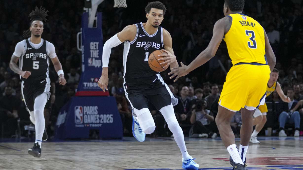 San Antonio Spurs center Victor Wembanyama (1) brings the ball up court under pressure from Indiana Pacers center Thomas Bryant (3) during the second half of a Paris Games 2025 NBA basketball game in Paris, Saturday, Jan. 25, 2025.