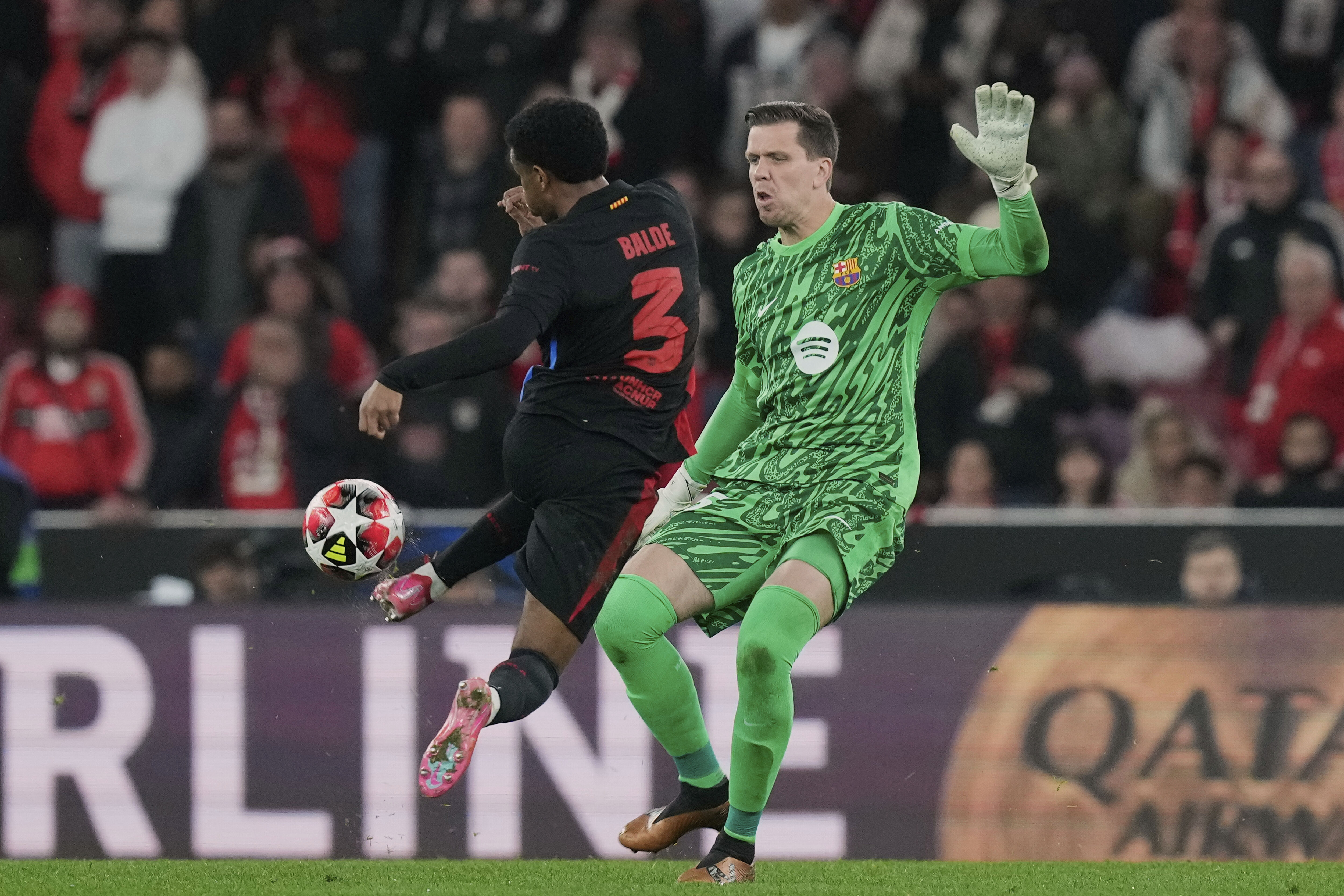 Barcelona's Alejandro Balde collides with Barcelona's goalkeeper Wojciech Szczęsny during a Champions League opening phase soccer match between SL Benfica and FC Barcelona at the Luz stadium in Lisbon, Tuesday, Jan. 21, 2025. 