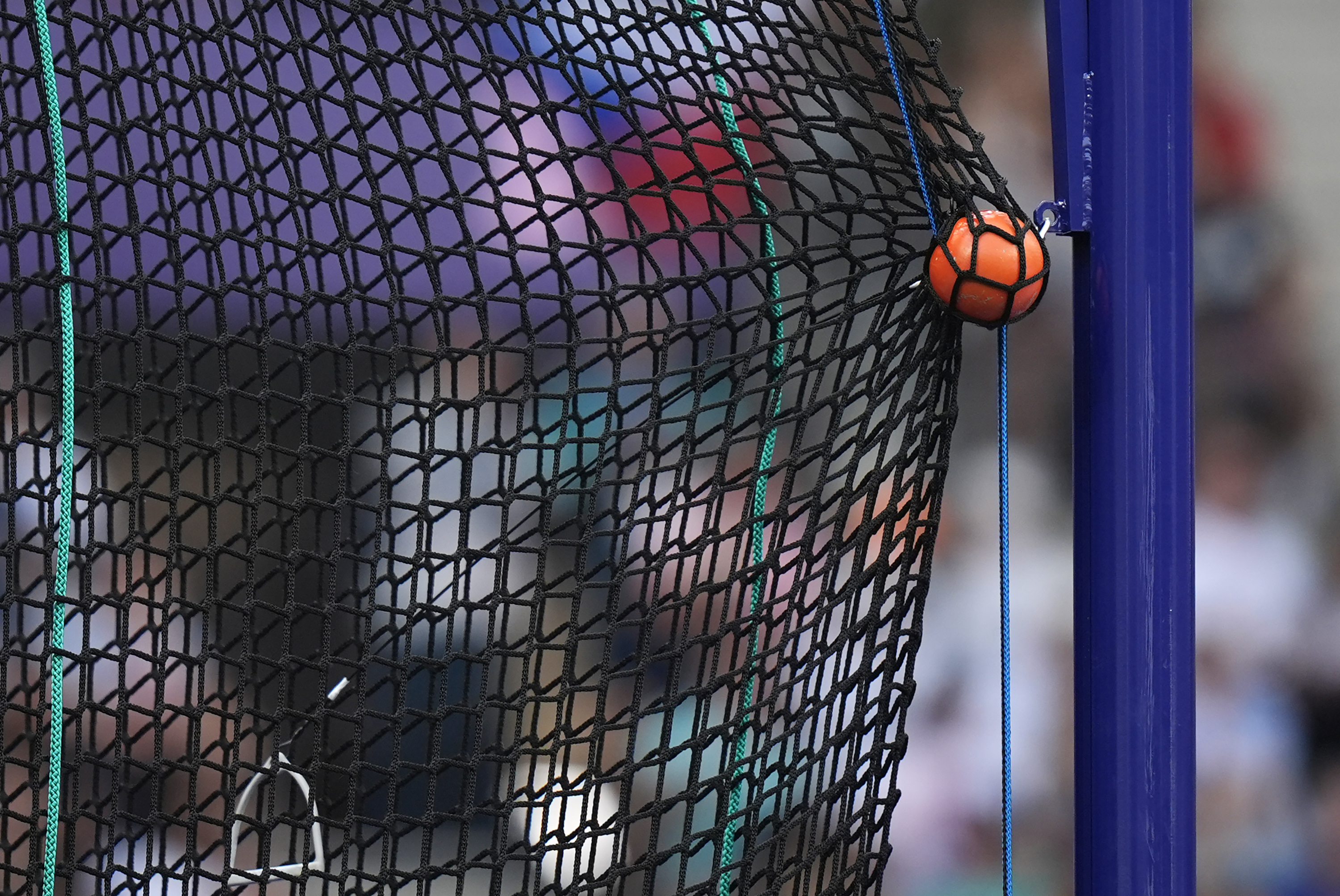 FILE - A hammer is caught by the safety net during the men's hammer throw qualification at the 2024 Summer Olympics, Aug. 2, 2024, in Saint-Denis, France. 