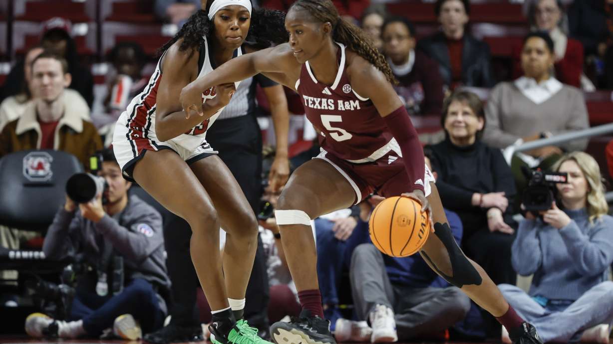 Texas A&M guard Aicha Coulibaly (5) drives against South Carolina guard Raven Johnson during the first half of an NCAA college basketball game in Columbia, S.C., Thursday, Jan. 9, 2025.