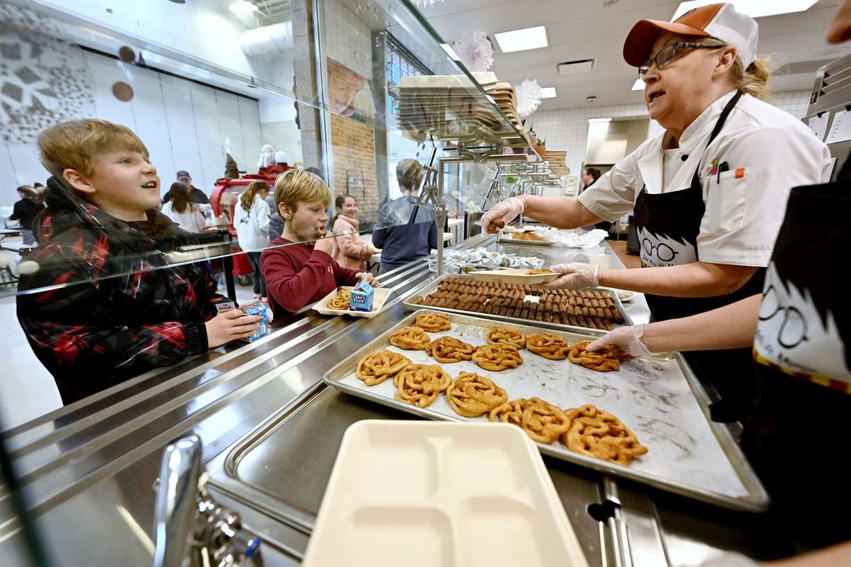 Debbie Gilstrap, kitchen manager and nutrition worker Stephanie Anderson serve food to kids at Butler Elementary school in Cottonwood Heights on Tuesday.