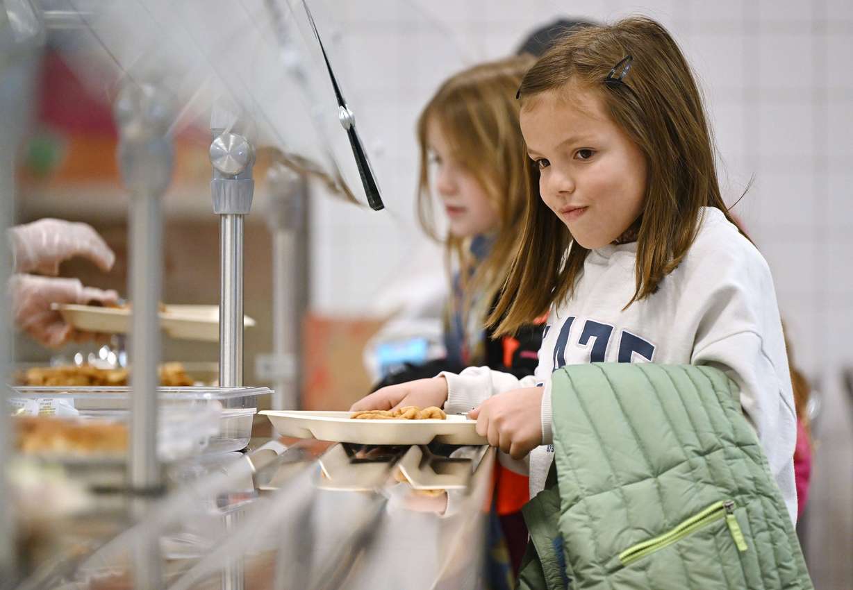 Kids at Butler Elementary school in Cottonwood Heights line up to receive their lunches on Tuesday.