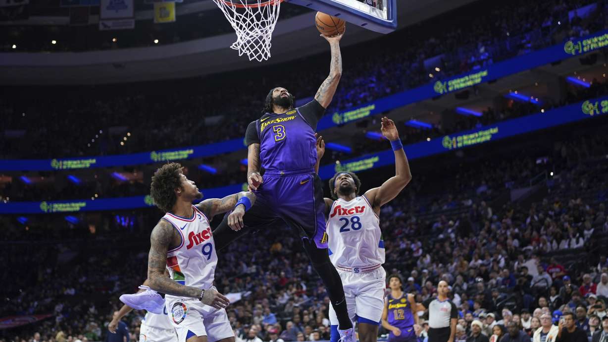 Los Angeles Lakers' Anthony Davis (3) goes up for a shot against Philadelphia 76ers' Guerschon Yabusele (28) and Kelly Oubre Jr. (9) during the first half of an NBA basketball game, Tuesday, Jan. 28, 2025, in Philadelphia.