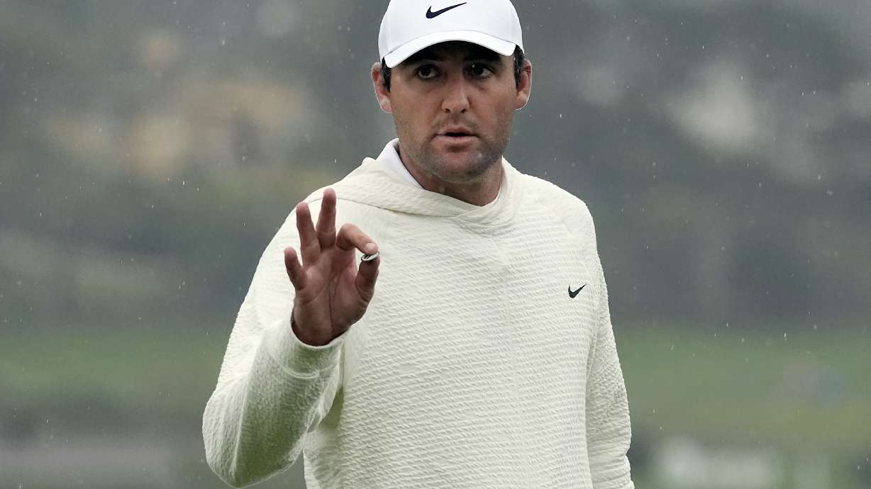 FILE - Scottie Scheffler gestures on the 18th green at Pebble Beach Golf Links during the third round of the AT&T Pebble Beach National Pro-Am golf tournament in Pebble Beach, Calif., Saturday, Feb. 3, 2024.
