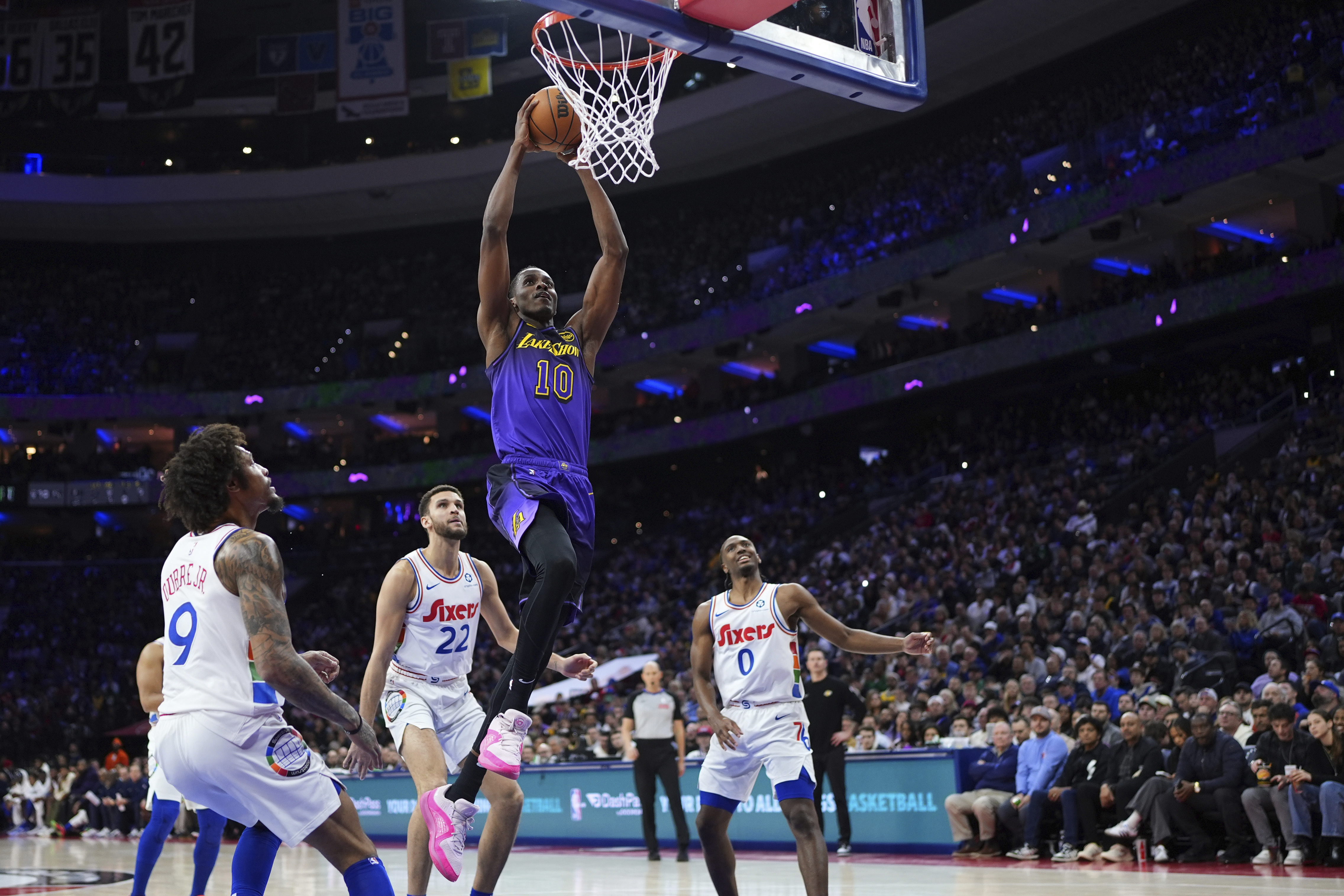 Los Angeles Lakers' Christian Koloko (10) goes up for a dunk past Philadelphia 76ers' Kelly Oubre Jr. (9), Pete Nance (22) and Tyrese Maxey (0) during the first half of an NBA basketball game, Tuesday, Jan. 28, 2025, in Philadelphia.