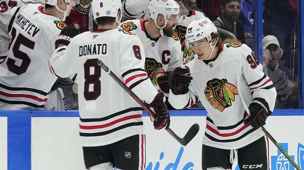 Chicago Blackhawks center Connor Bedard (98) celebrates his goal against the Tampa Bay Lightning with center Ryan Donato (8) during the second period of an NHL hockey game Tuesday, Jan. 28, 2025, in Tampa, Fla.