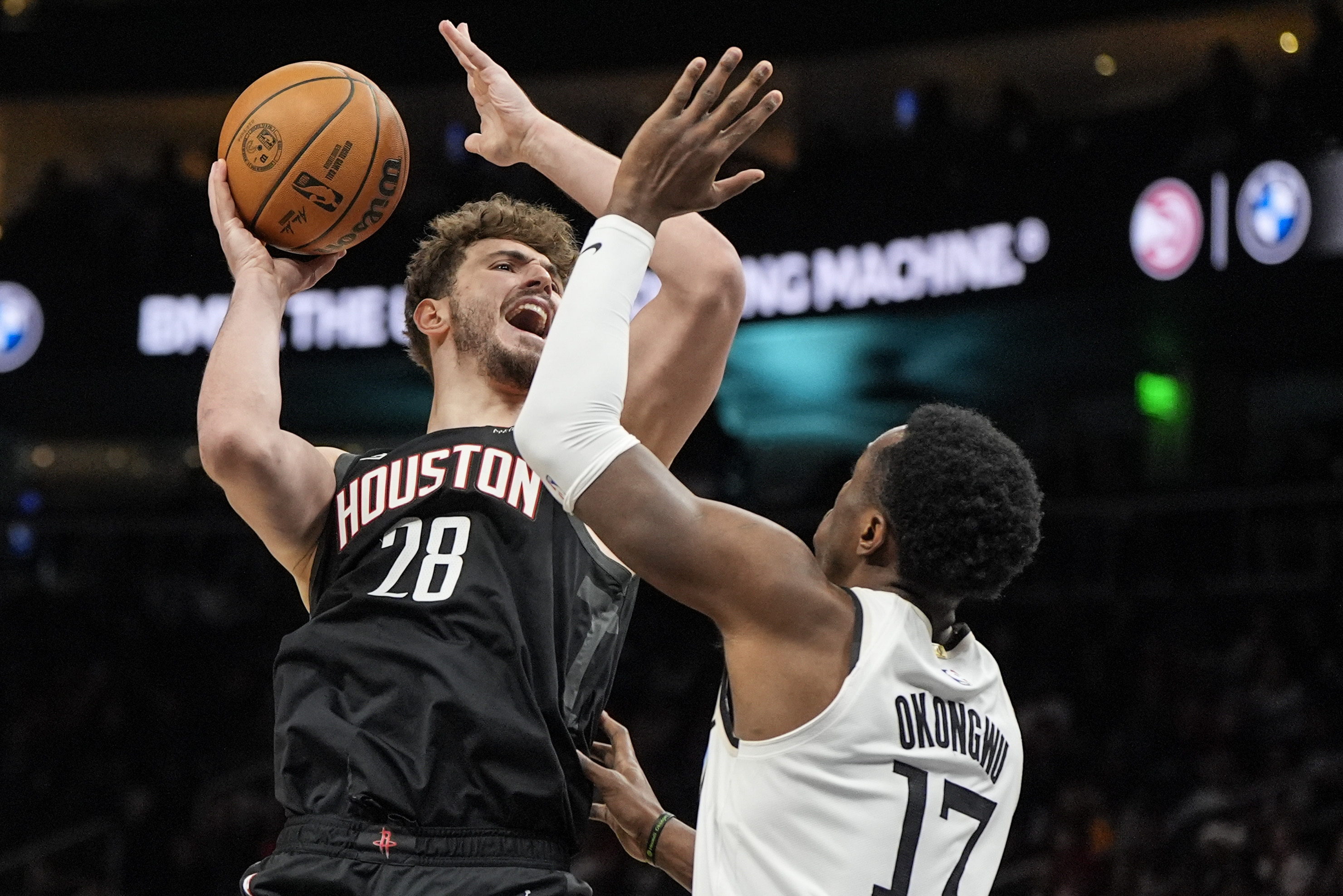 Houston Rockets center Alperen Sengun (28) shoots against Atlanta Hawks forward Onyeka Okongwu (17) during the first half of an NBA basketball game, Tuesday, Jan. 28, 2025, in Atlanta. 