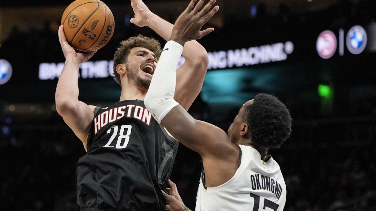 Houston Rockets center Alperen Sengun (28) shoots against Atlanta Hawks forward Onyeka Okongwu (17) during the first half of an NBA basketball game, Tuesday, Jan. 28, 2025, in Atlanta.