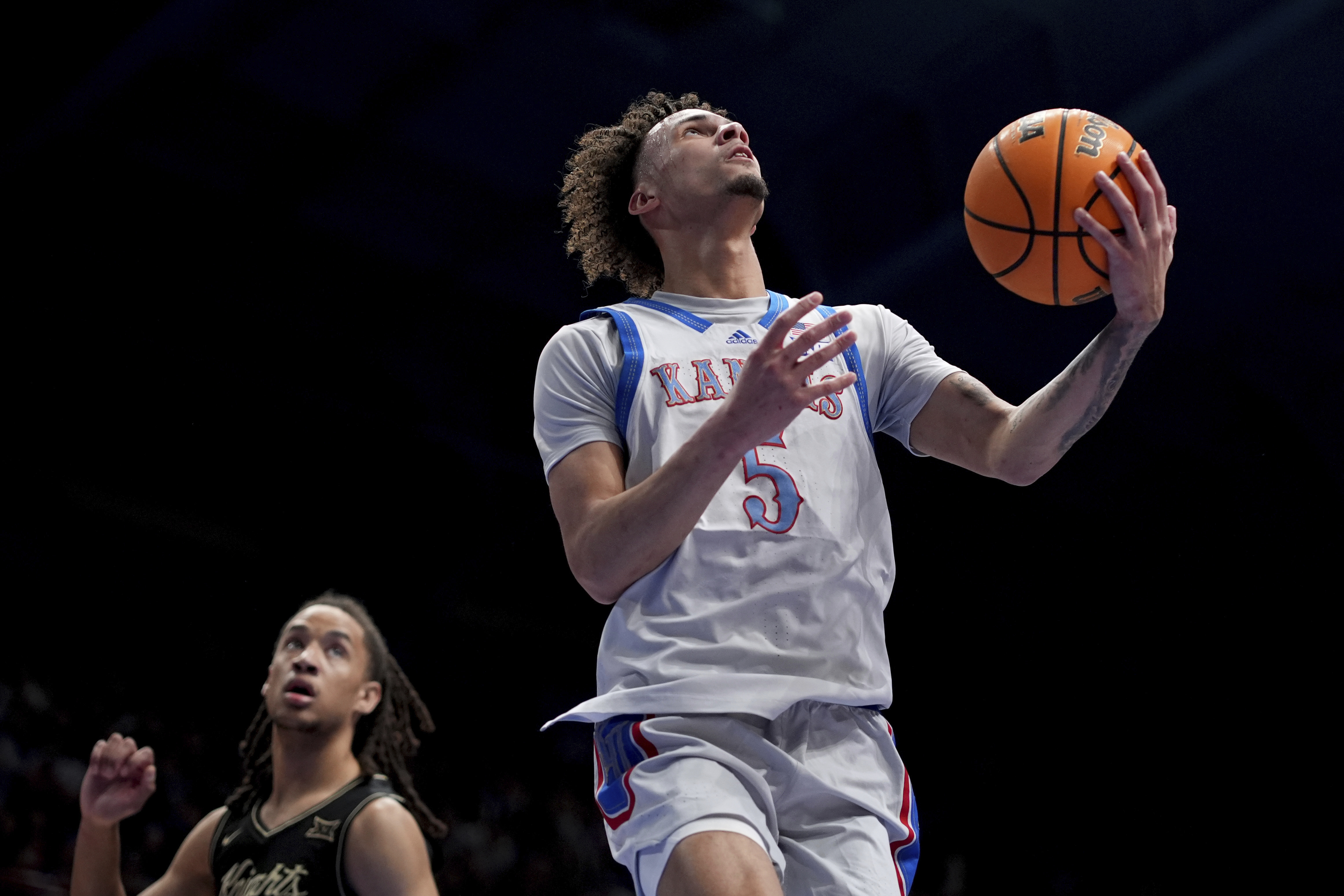 Kansas guard Zeke Mayo (5) puts up a shot during the first half of an NCAA college basketball game against UCF, Tuesday, Jan. 28, 2025, in Lawrence, Kan.