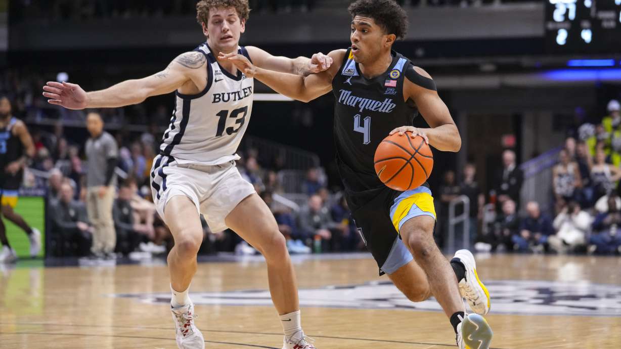 Marquette guard Stevie Mitchell (4) drives on Butler guard Finley Bizjack (13) in the first half of an NCAA college basketball game in Indianapolis, Tuesday, Jan. 28, 2025.