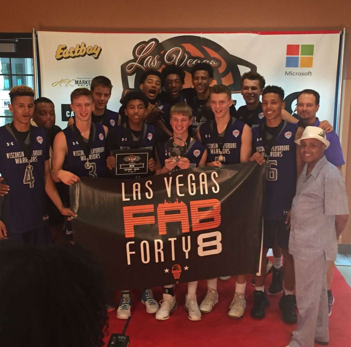 Mason and Gabe Madsen pose for a picture with their AAU basketball team.