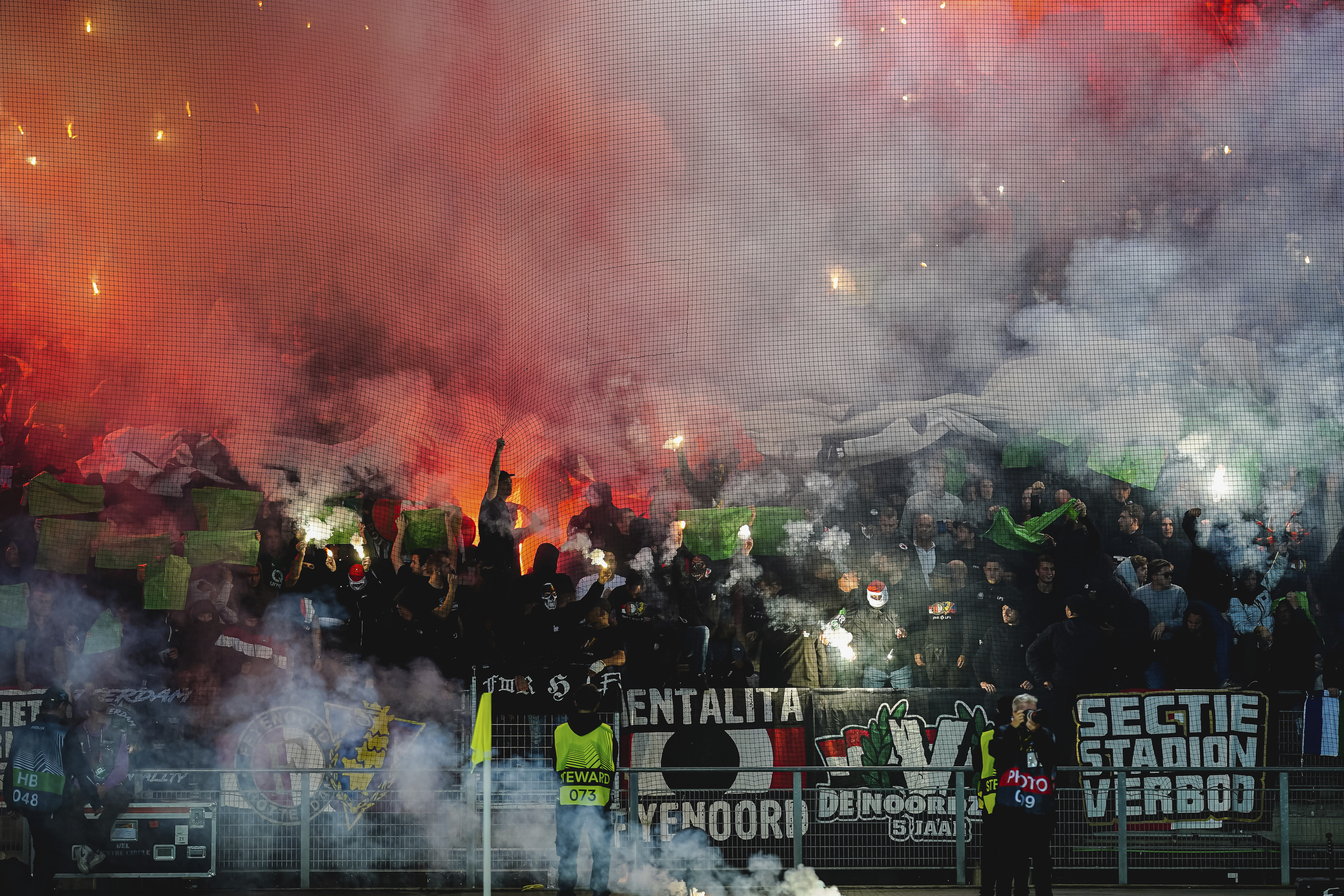 FILE - Fans of Feyenoord light flares during the Europa League Group F soccer match between Sturm Graz and Feyenoord at the Merkur Arena in Graz, Austria, Thursday, Oct. 27, 2022. 