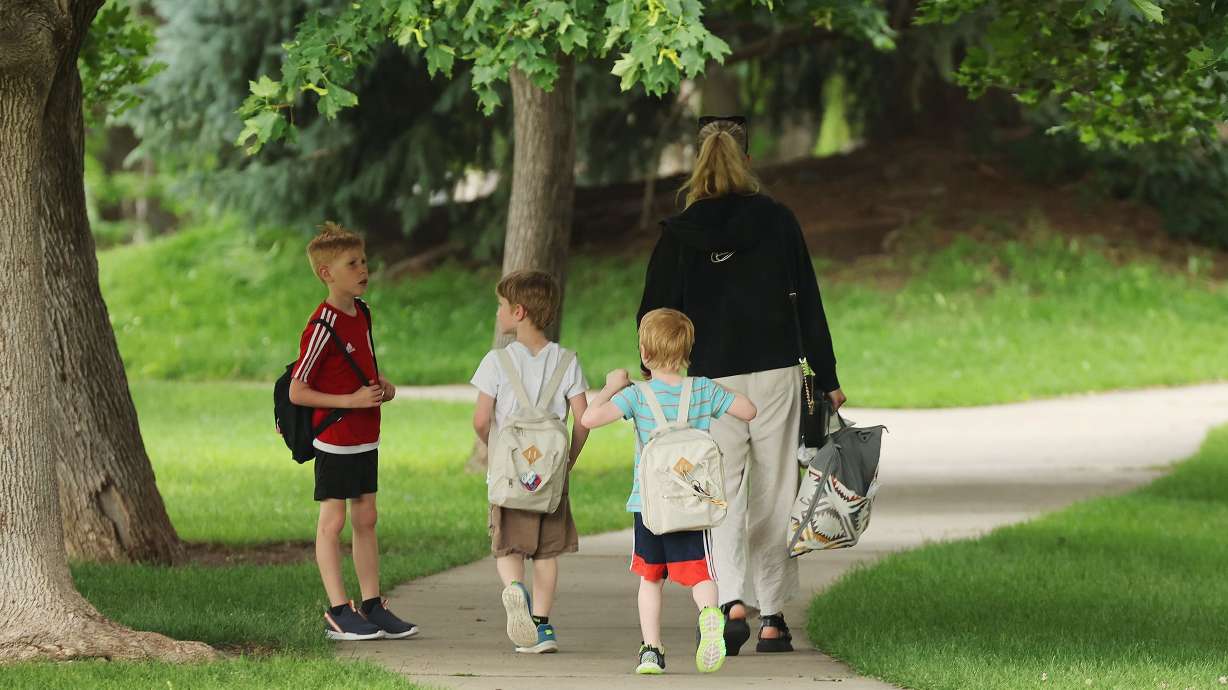 A mother and her children walk in Canyon Rim Park in Millcreek on June 21, 2024. A bill expanding child tax credit in Utah to include a wider age range of children was introduced in the Utah Legislature.