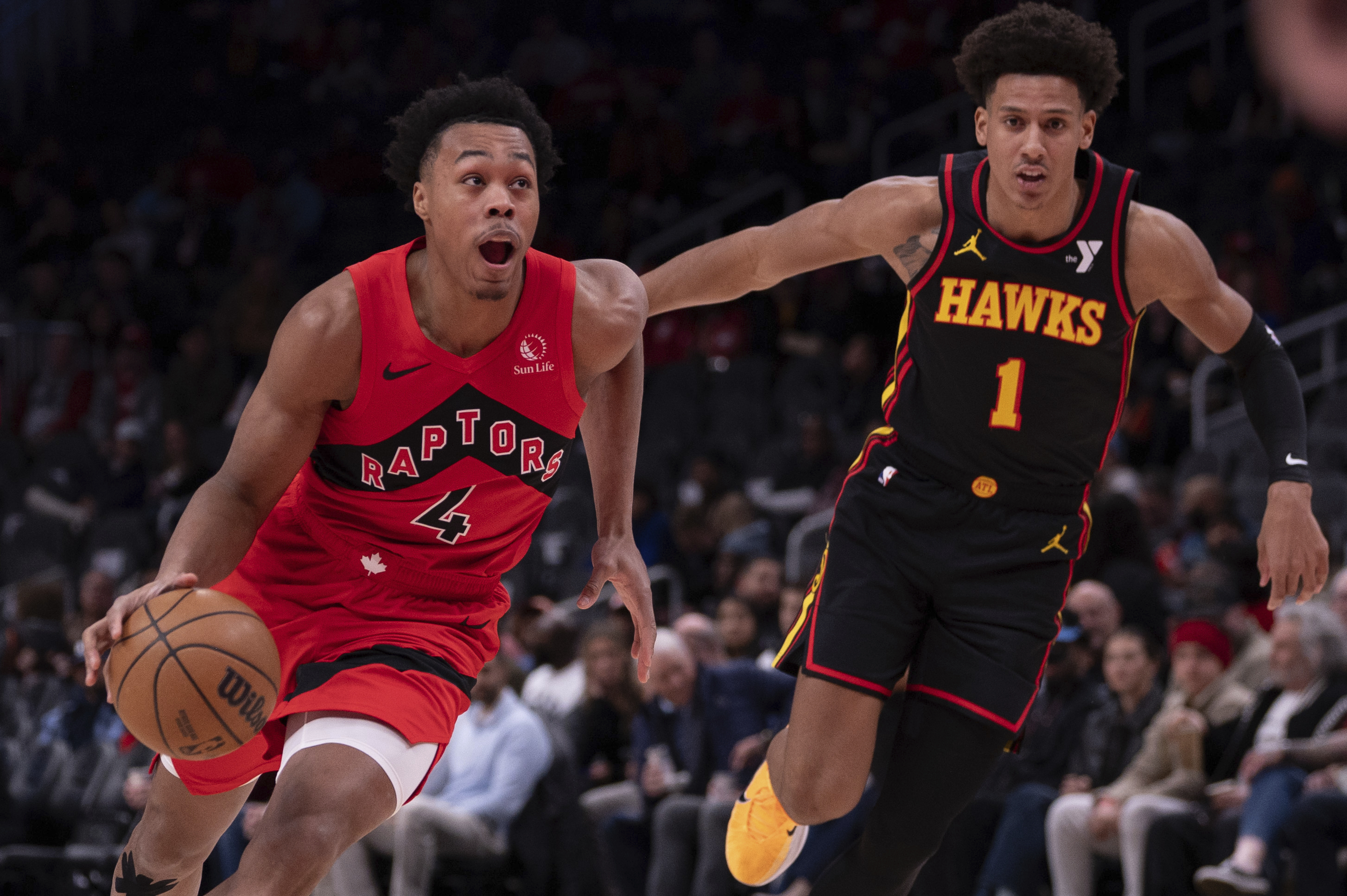 Toronto Raptors forward Scottie Barnes (4) dribbles the ball past Atlanta Hawks forward Jalen Johnson (1) during the first half of an NBA basketball game, Thursday, Jan. 23, 2025, in Atlanta.