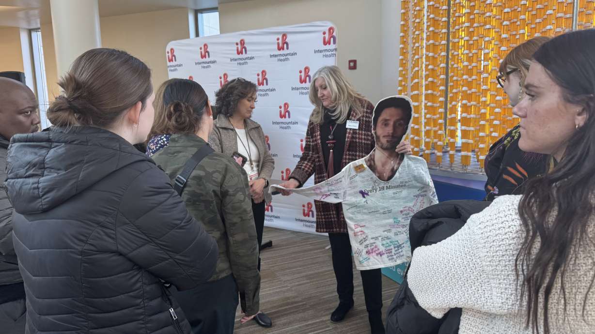 Terry Olsen shows a cardboard cutout of her son, Dane Olsen, who died of a drug overdose following an ATV accident and opioid prescriptions at a press conference celebrating a 41% decrease in prescribed opioids in Utah since 2017 on Tuesday.