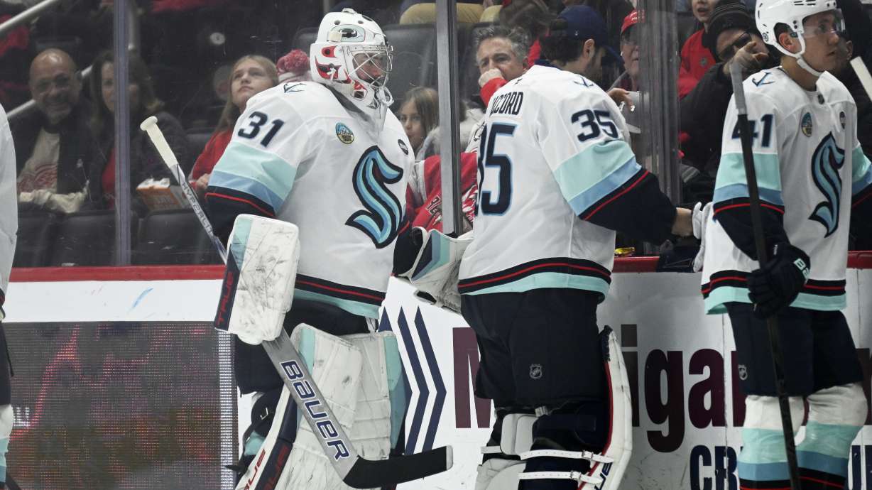 Seattle Kraken goaltender Philipp Grubauer (31) is taken out of the game after surrendering three goals against the Detroit Red Wings as Seattle Kraken goaltender Joey Daccord (35) prepares to enter the game during the first period of an NHL hockey game, Sunday, Jan. 12, 2025, in Detroit.