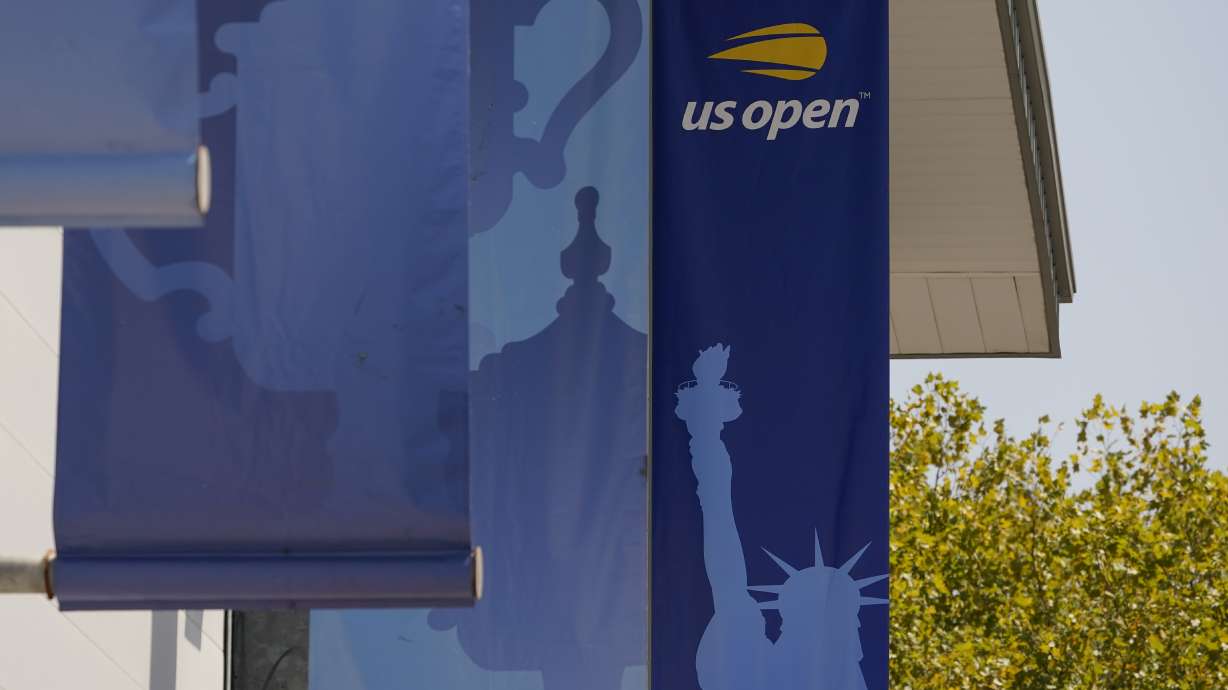 FILE- Banners are displayed on the grounds of the U.S. Open tennis tournament in New York, Thursday, Aug. 25, 2022.