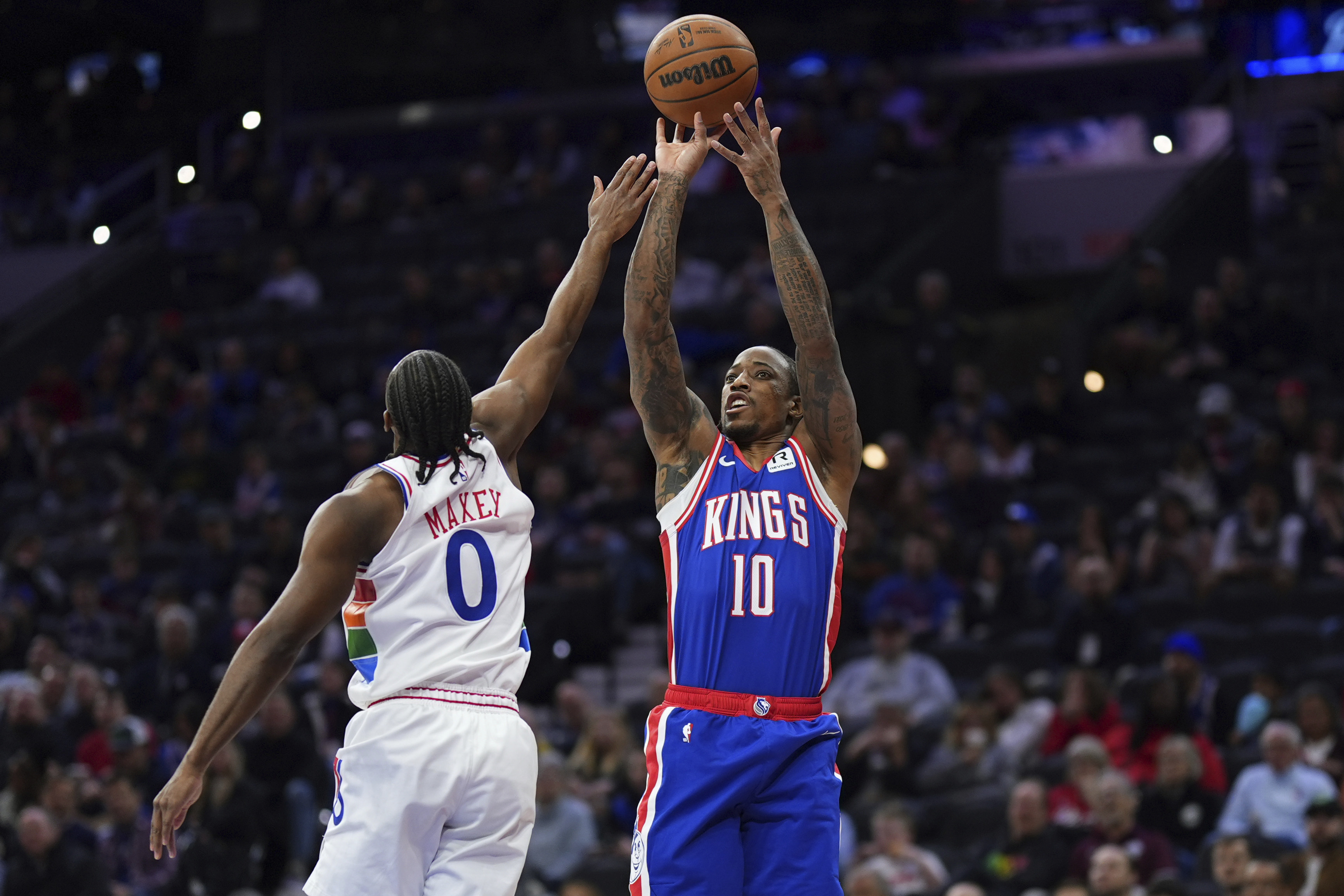 Sacramento Kings' DeMar DeRozan, right, goes up for a shot against Philadelphia 76ers' Tyrese Maxey during the first half of an NBA basketball game, Wednesday, Jan. 29, 2025, in Philadelphia. 
