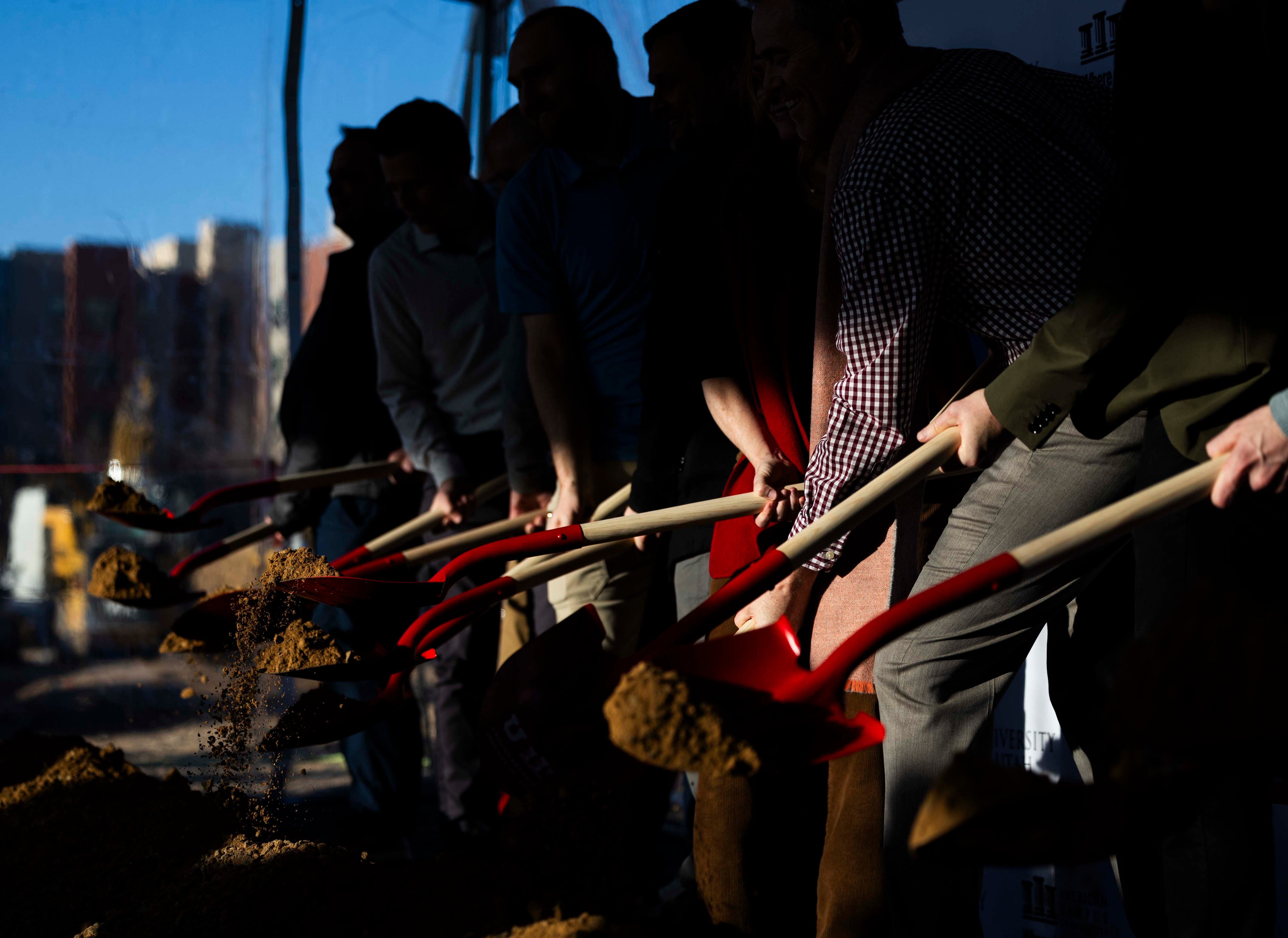 People from the University of Utah and construction partners participate in a groundbreaking for a $155 million, 1,400-bed University of Utah student housing development, at Kahlert Village on the campus of the University of Utah in Salt Lake City on Wednesday.