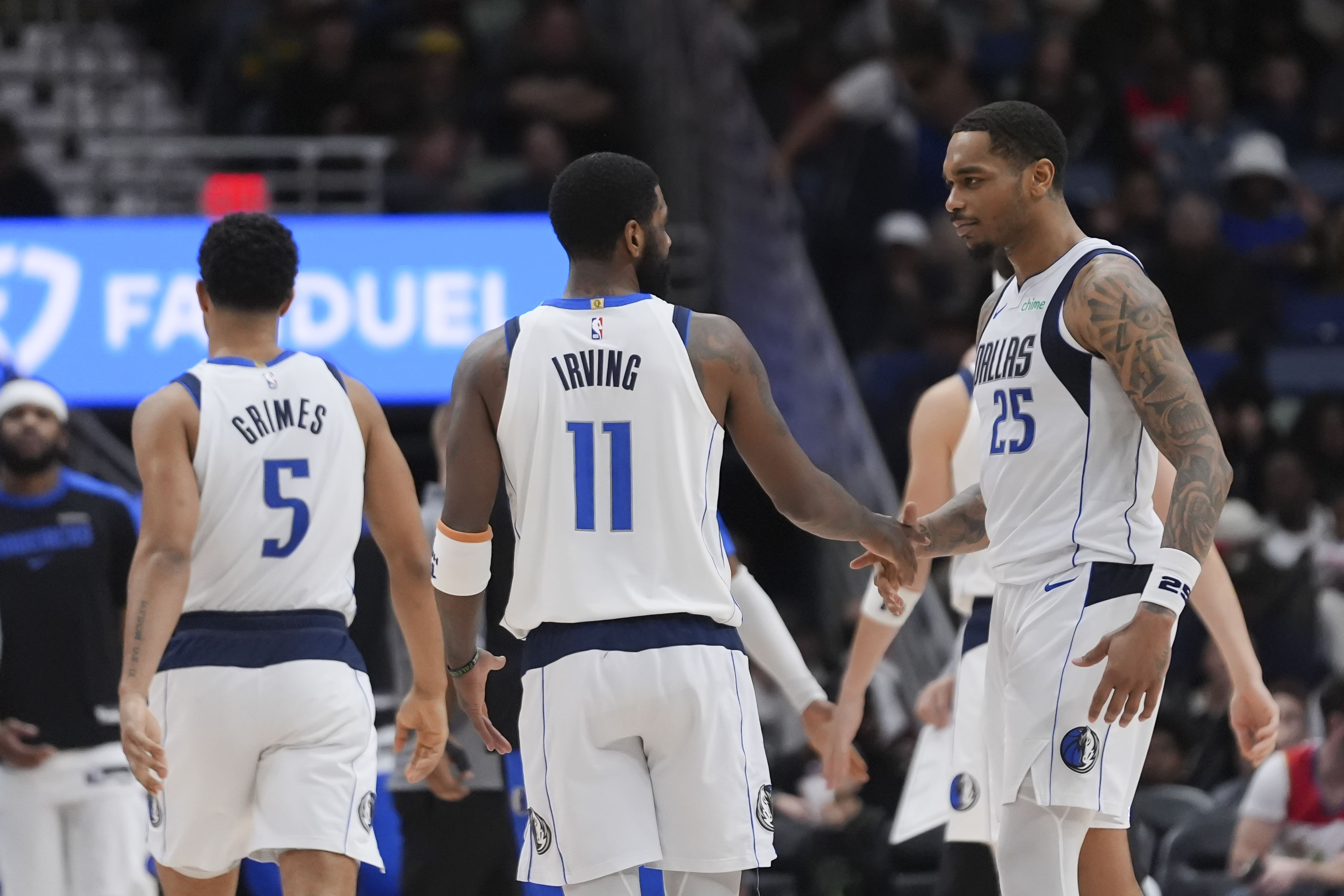 Dallas Mavericks forward P.J. Washington (25) celebrates his 3-point shot with guard Kyrie Irving (11) in the second half of an NBA basketball game against the New Orleans Pelicans in New Orleans, Wednesday, Jan. 29, 2025. 