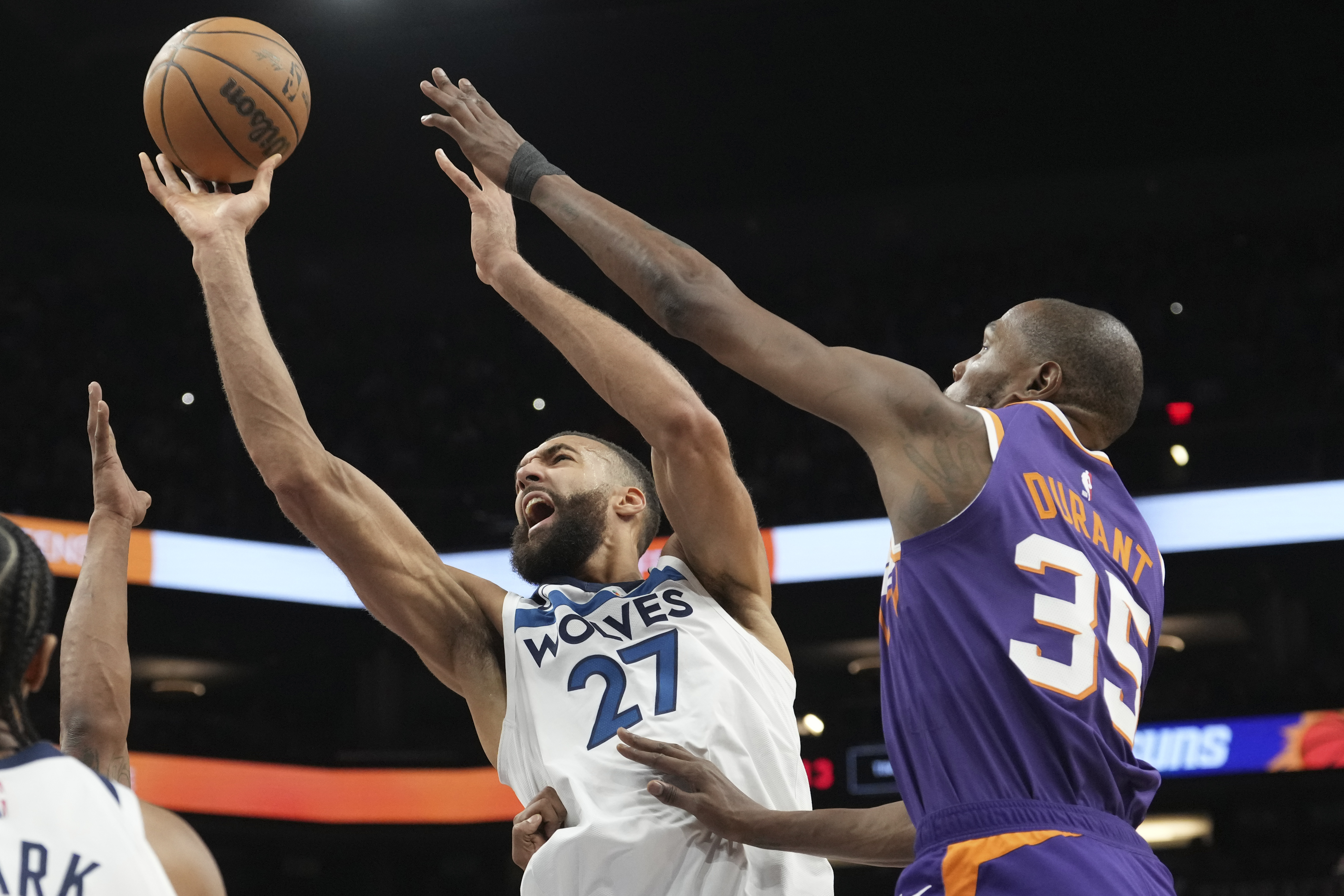 Minnesota Timberwolves center Rudy Gobert (27) gets off a shot against Phoenix Suns forward Kevin Durant (35) during the first half of an NBA basketball game Wednesday, Jan. 29, 2025, in Phoenix.